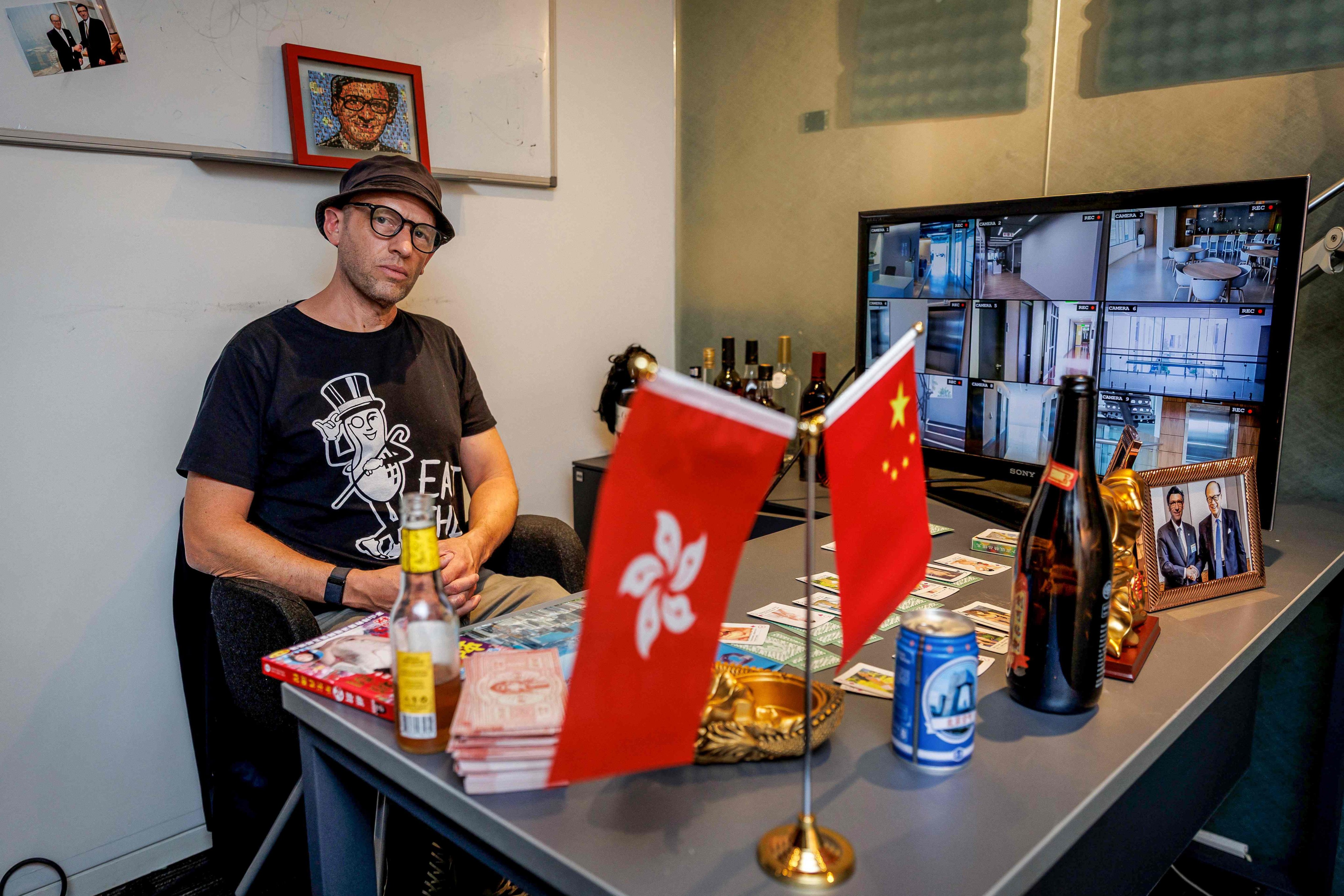 Hong Kong-based British artist Dominic Johnson-Hill sits with his installation in the “boss’ office” at “Re:Urgent”, an exhibition at Young Soy Gallery in Central, Hong Kong. Photo: AFP