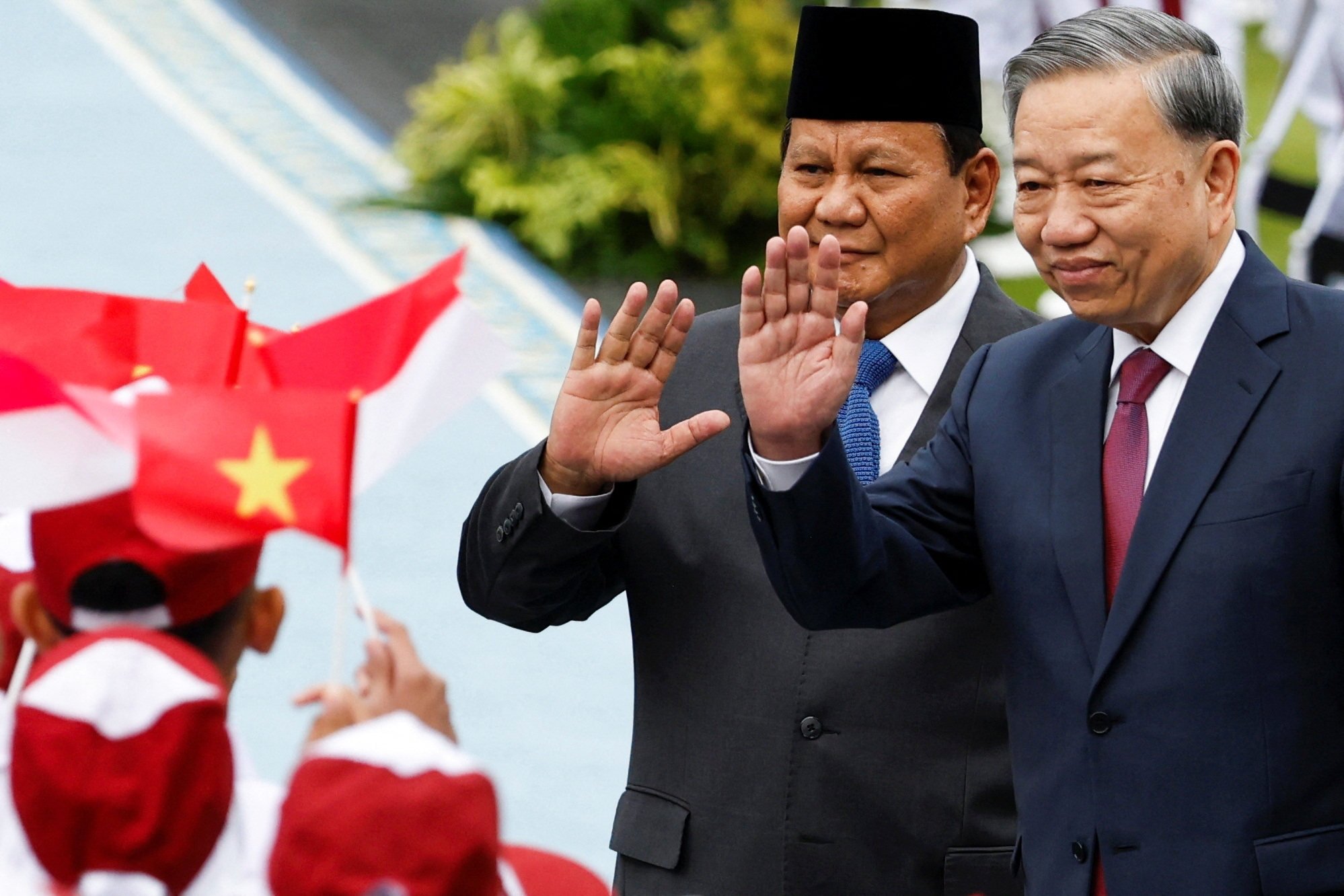 Indonesian President Prabowo Subianto and Vietnam’s Communist Party General Secretary To Lam wave to students at a welcoming ceremony in Jakarta on March 10. Photo: Reuters