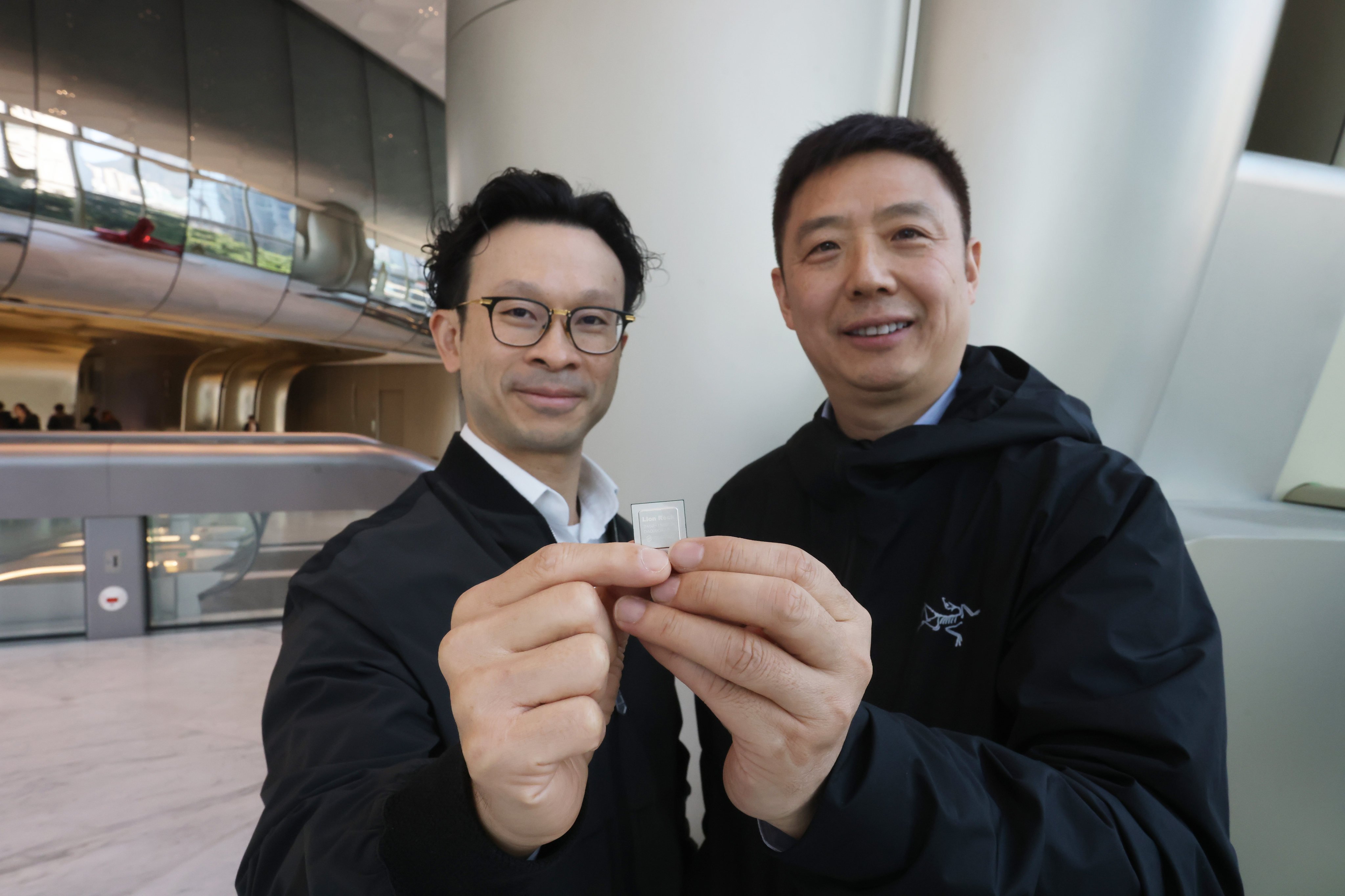 Full Vision Capital managing partner Alan Chan, left, and StarFive CEO Thomas Xu, holding a RISC-V chip. Photo: Jonathan Wong