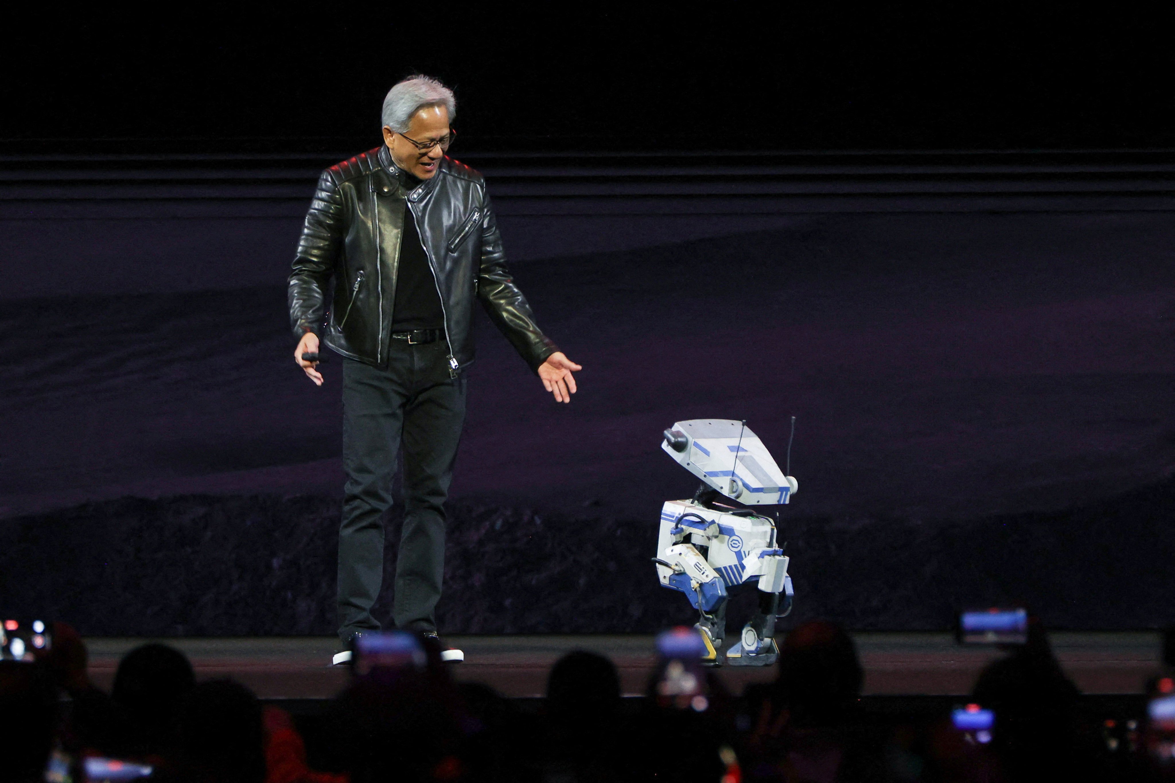 Nvidia CEO Jensen Huang interacts with a small robot on stage during the keynote for the Nvidia GPU Technology Conference (GTC) at the SAP Centre in San Jose, California on Thursday. Photo: Reuters