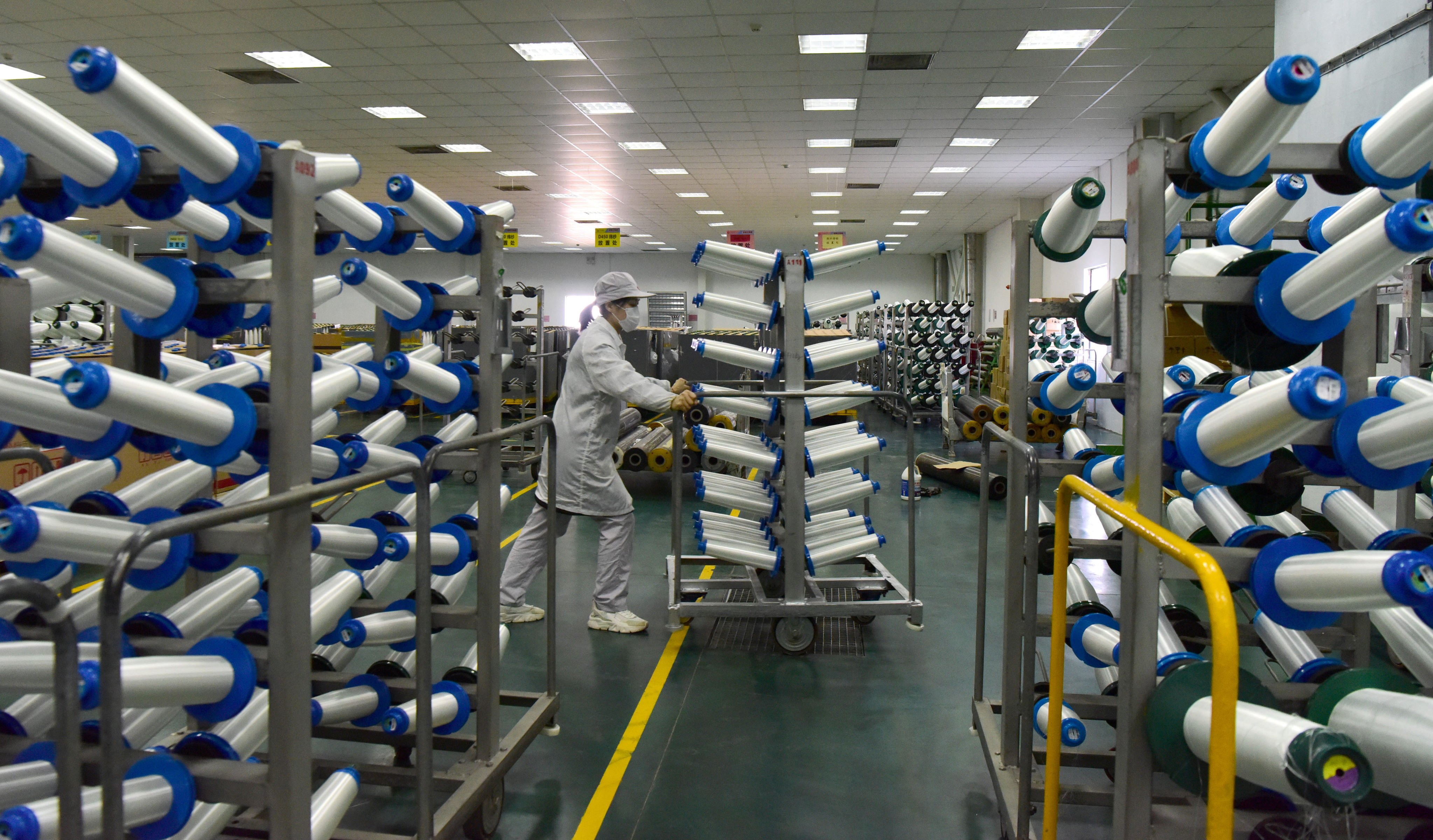 A staff member transports materials at a private new-material firm in China’s Henan province. It should soon become easier for the nation’s small and medium-sized firms to collect back-owed payments. Photo: Xinhua