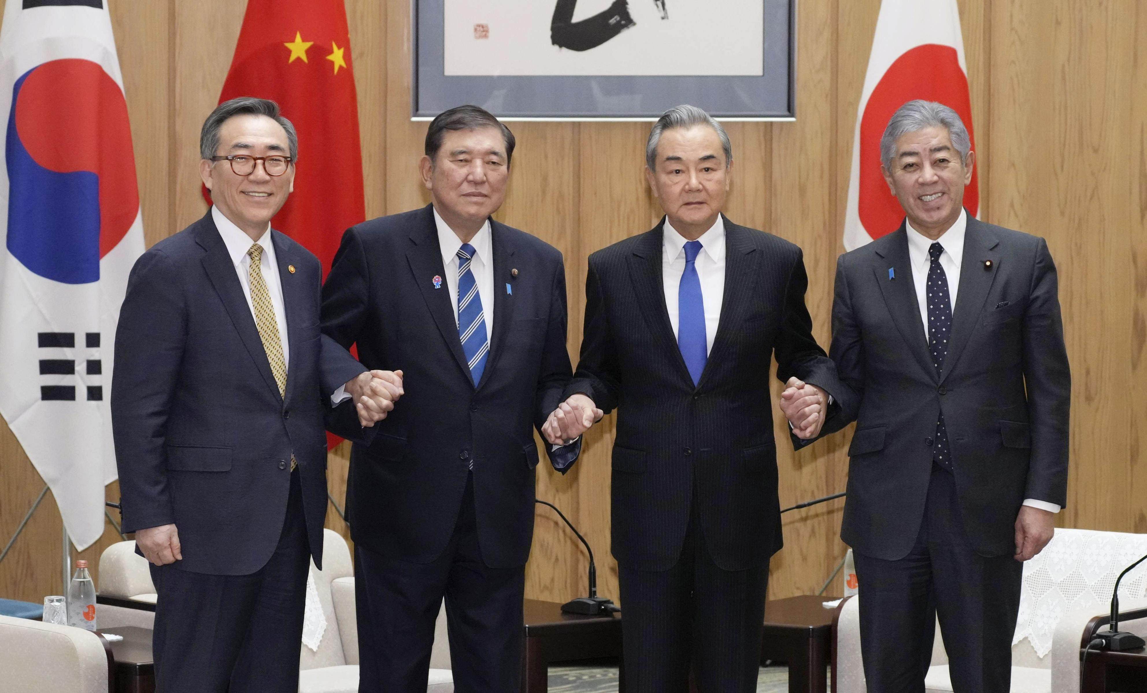 Japanese Prime Minister Shigeru Ishiba (second left) with foreign ministers (from left) Cho Tae-yul of South Korea, Wang Yi of China and Takeshi Iwaya of Japan, at Ishiba’s office in Tokyo on March 21. Photo: Kyodo