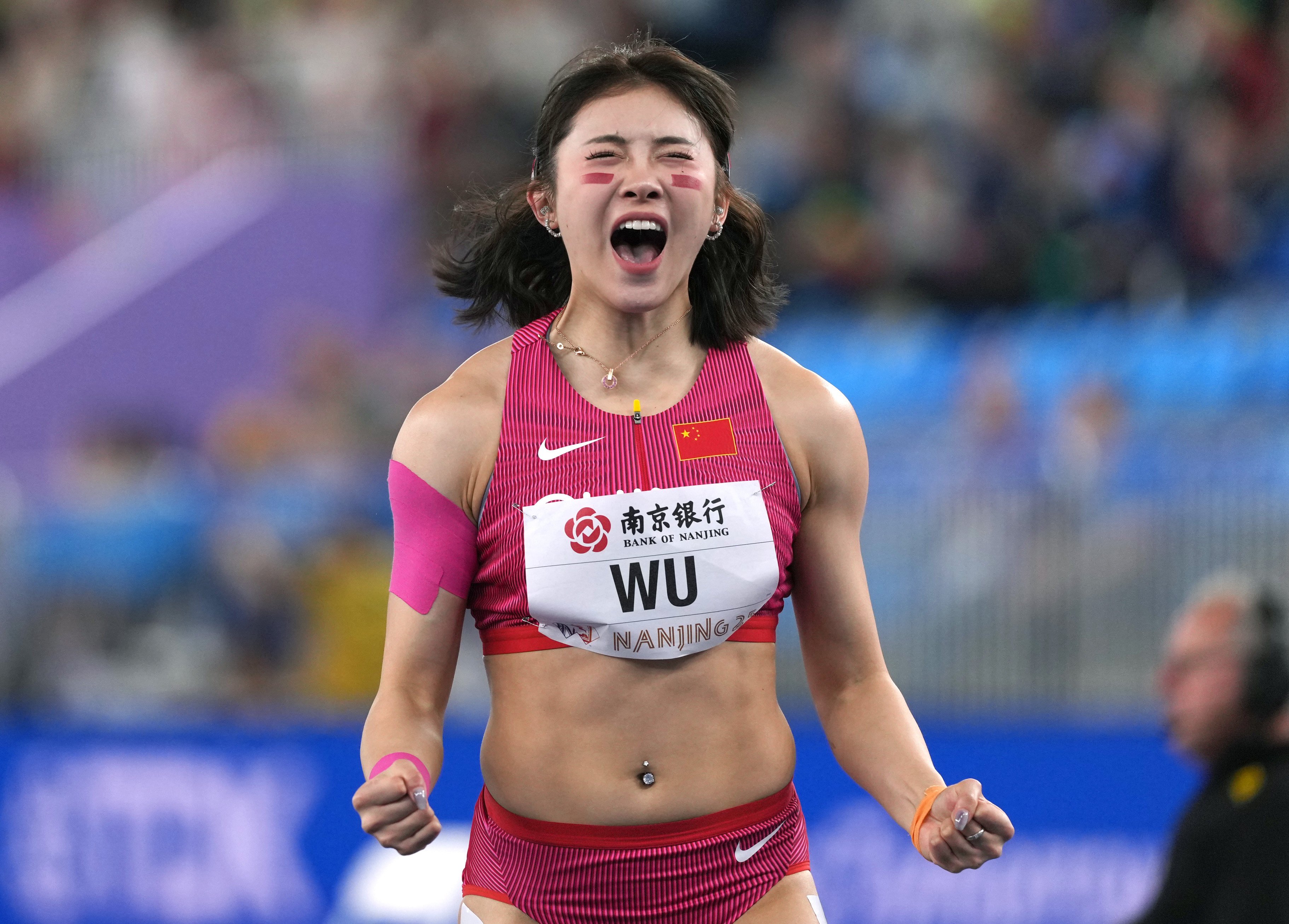 Wu Yanni celebrates after breaking the national record in women’s 60m hurdles at the World Athletics Indoor Championships. Photo: Xinhua