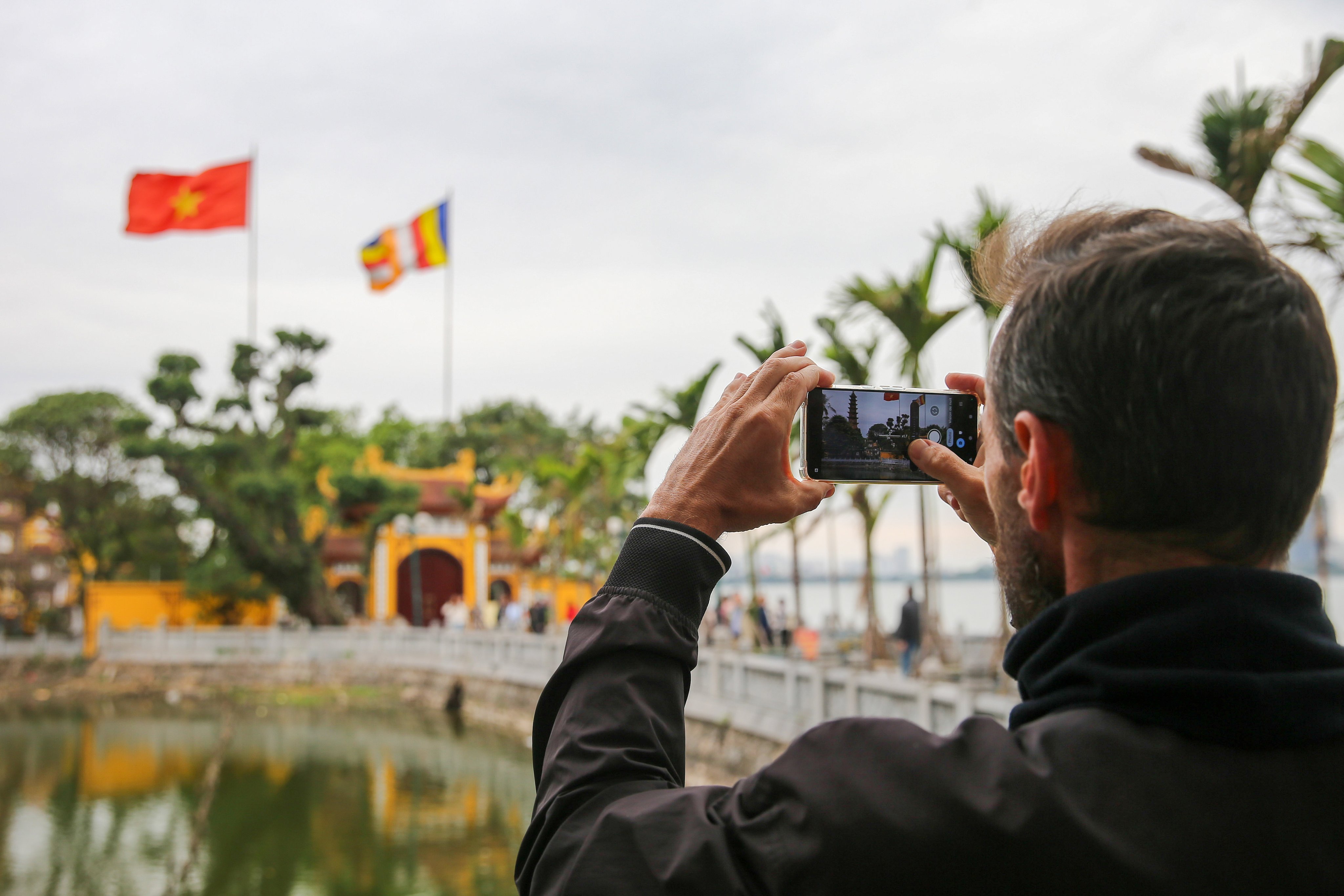 A tourist takes photos of a pagoda in Hanoi earlier this month. Vietnam is the regional leader in terms of its tourism recovery pace. Photo: EPA-EFE