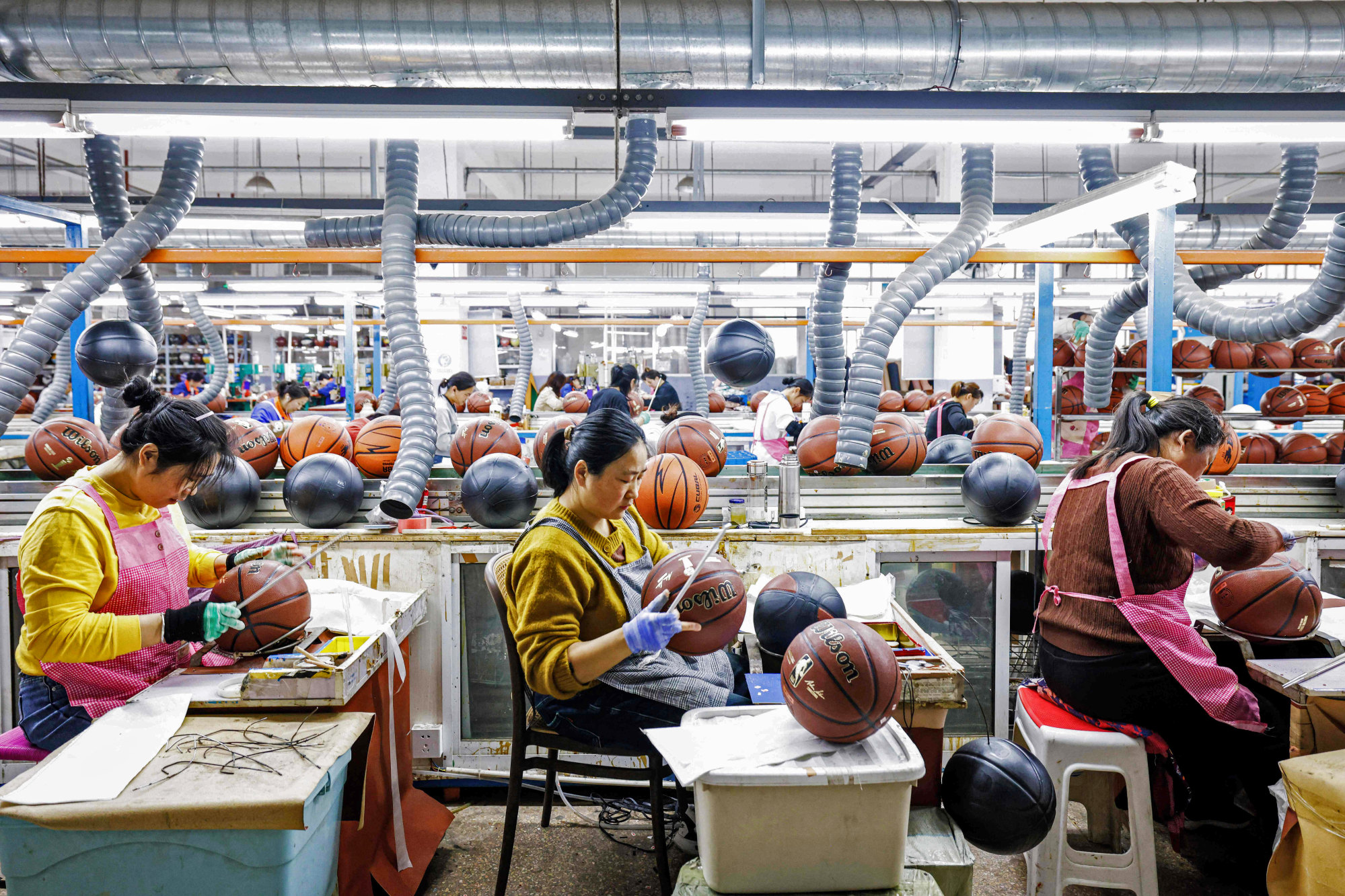 Basketballs are produced for exports at a factory in Sihong, in eastern China’s Jiangsu province. Photo: Agence France-Presse Basketballs are produced for exports at a factory in Sihong, in eastern China’s Jiangsu province. Photo: Agence France-Presse