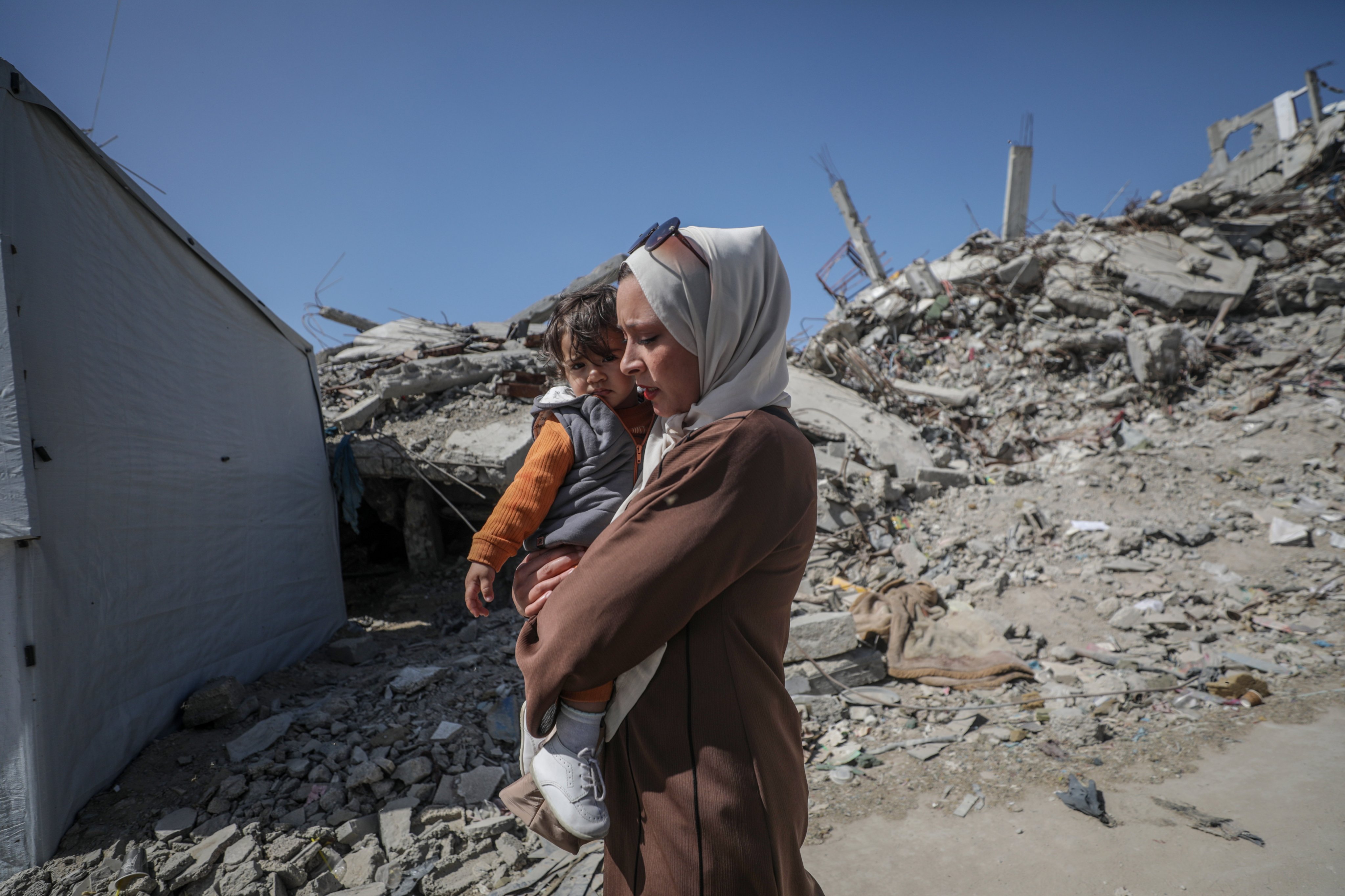 Internally displaced Palestinians walk past the rubble of destroyed buildings in the Jabalia refugee camp, northern Gaza Strip, on Thursday. Photo: EPA-EFE
