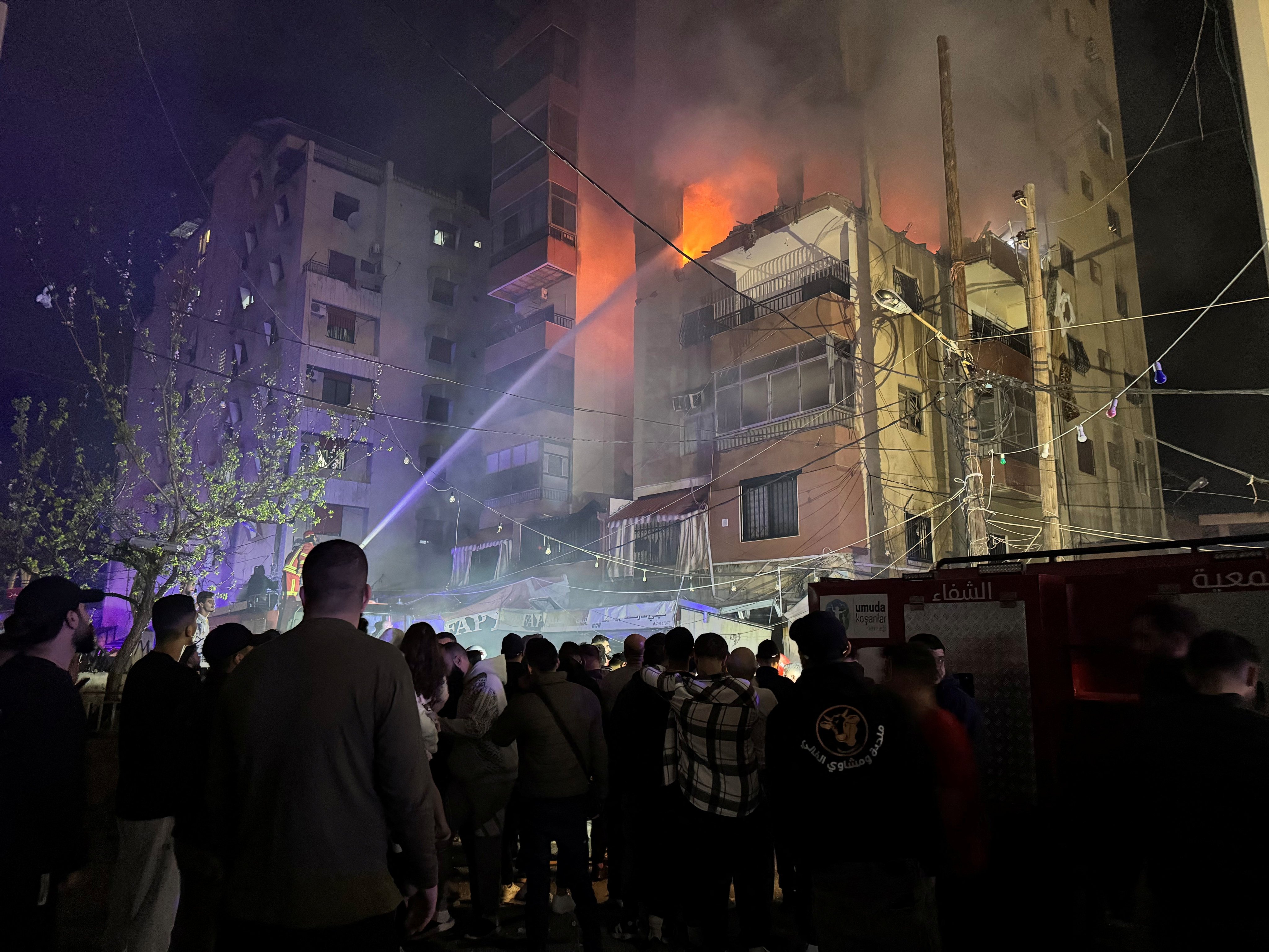 Firefighters try to put out a fire at a building following an Israeli strike, in which the Israeli military said it killed Hamas commander Hassan Farhat, in Sidon, Lebanon on Friday. Photo: Reuters