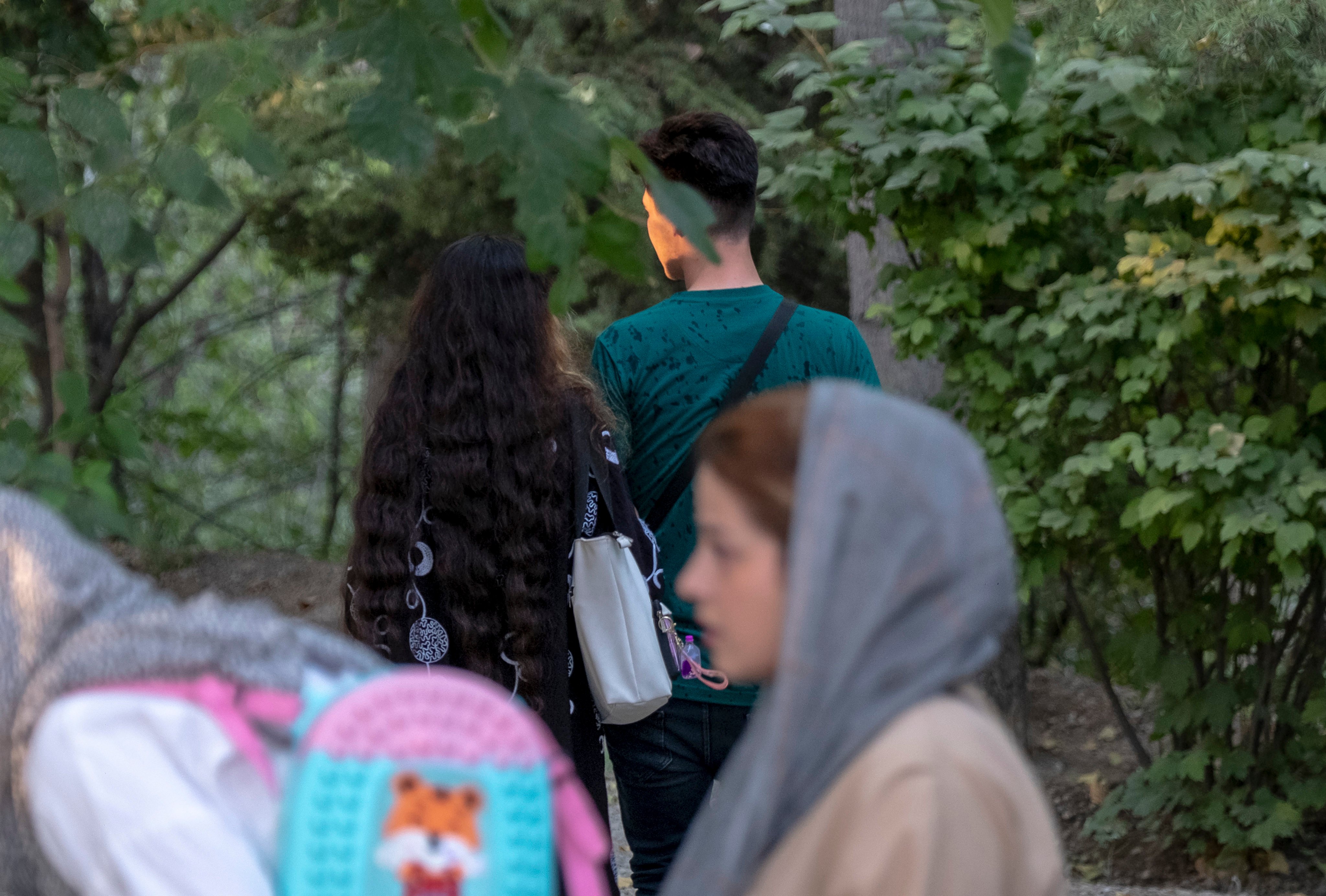 An Iranian couple walk together in a park in central Tehran. Photo: NurPhoto via Getty Images