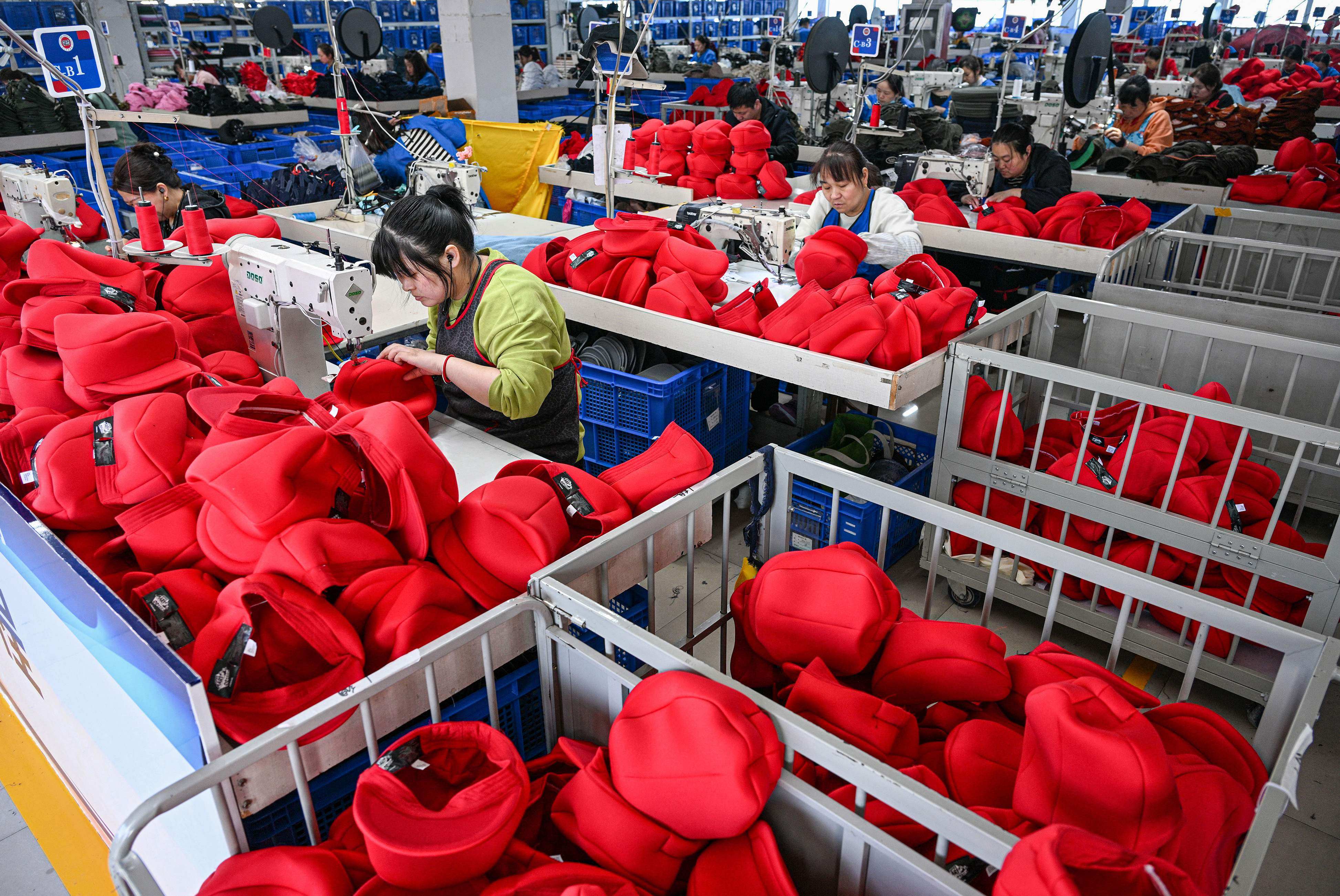 Employees work on a production line of caps for export to the United States  at a factory in Suqian, eastern China’s Jiangsu province. Photo: AFP