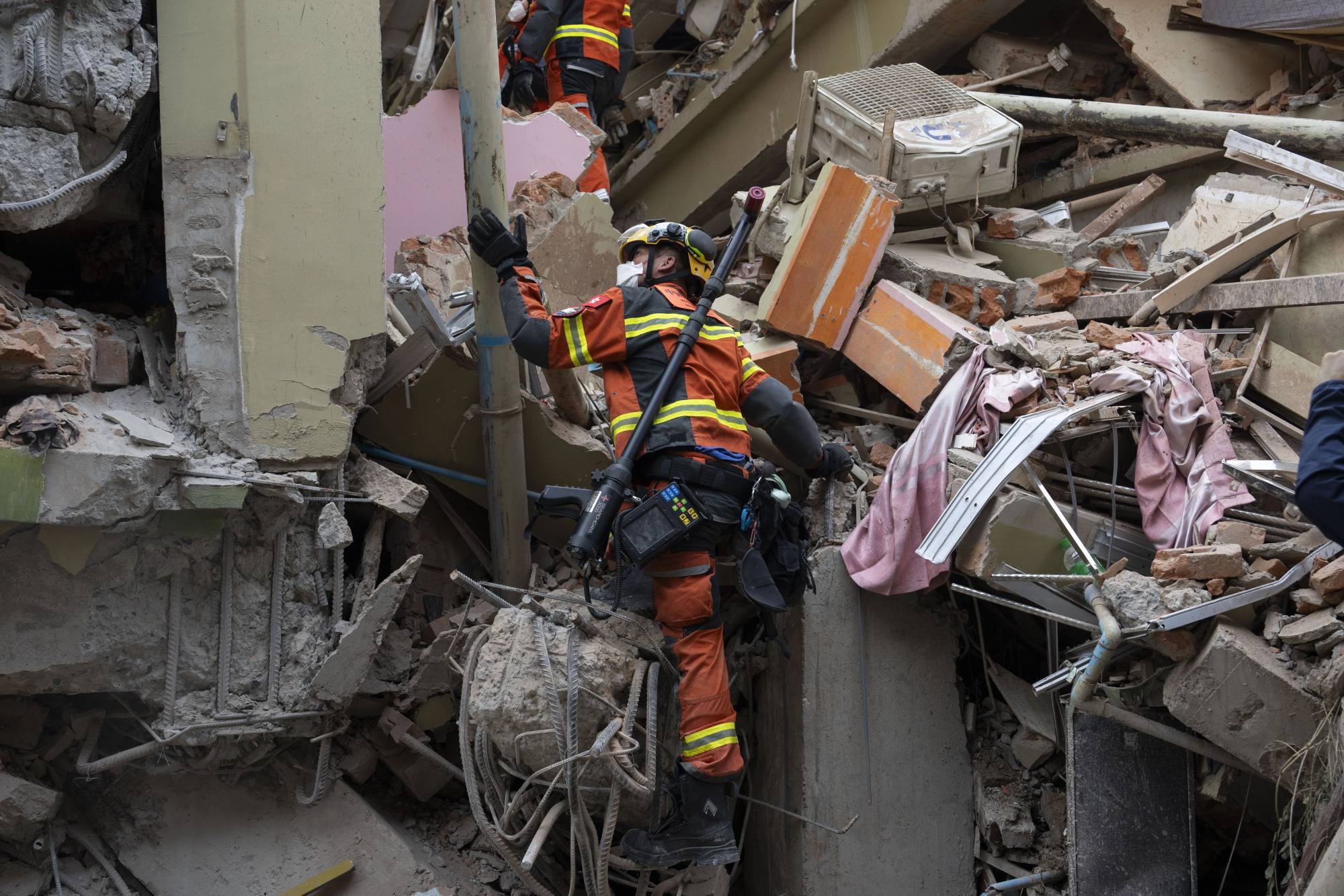 Hong Kong and mainland rescuers search through rubble during a joint operation in Mandalay. Photo: Xinhua Hong Kong and mainland rescuers search through rubble during a joint operation in Mandalay. Photo: Xinhua
