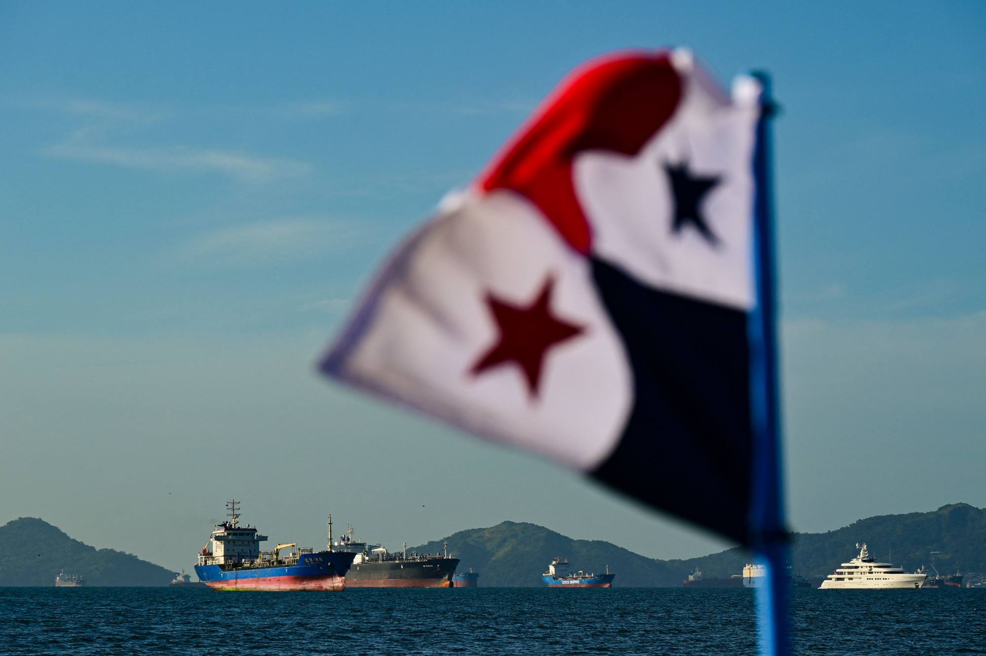 A Panamanian flag flutters as ships wait to enter the Panama Canal. Photo: AFP A Panamanian flag flutters as ships wait to enter the Panama Canal. Photo: AFP