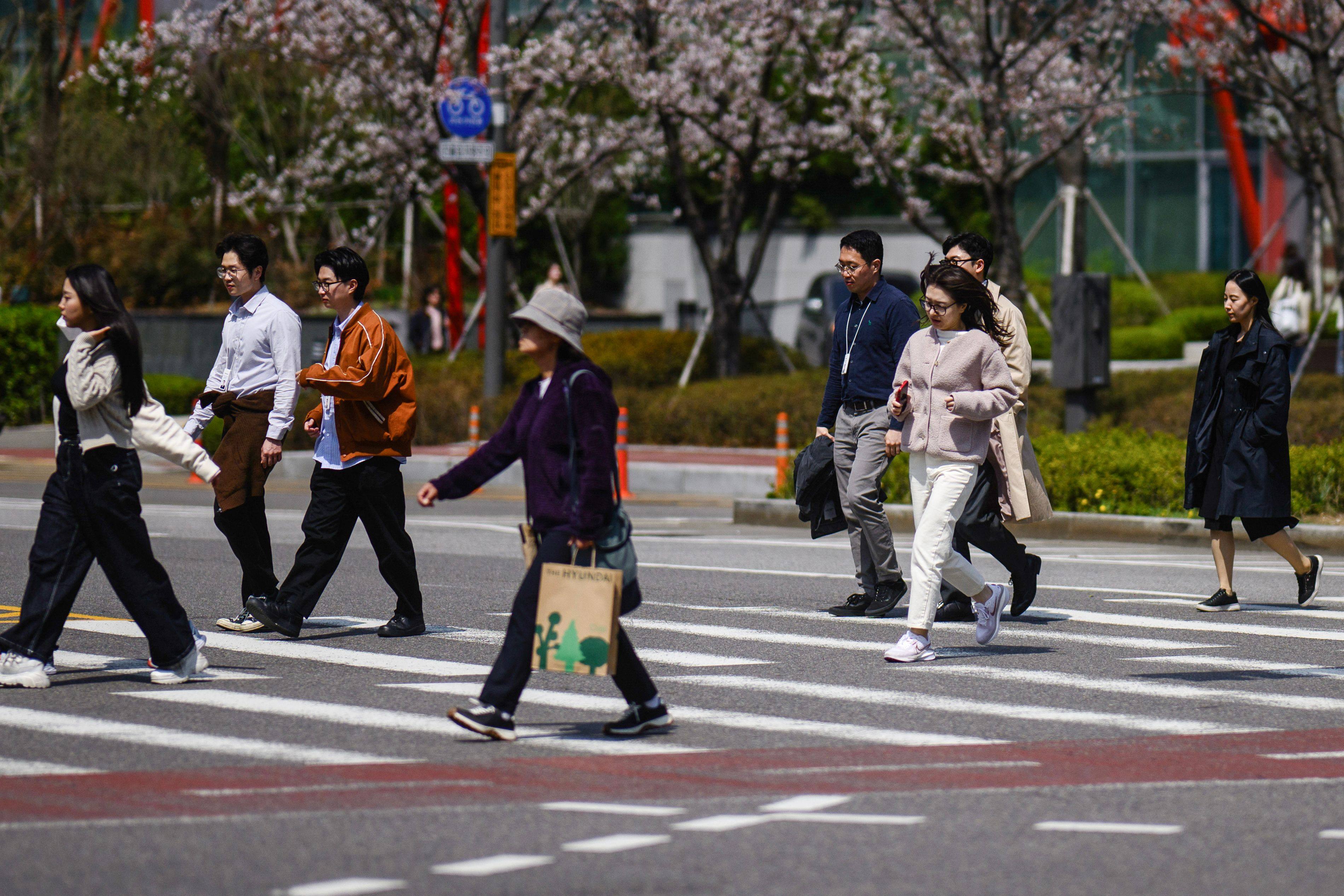 People walk across a road in Seoul on April 7. According to the latest Statistics Korea data, the number of single-person households reached 7.82 million in 2023. Photo: AFP