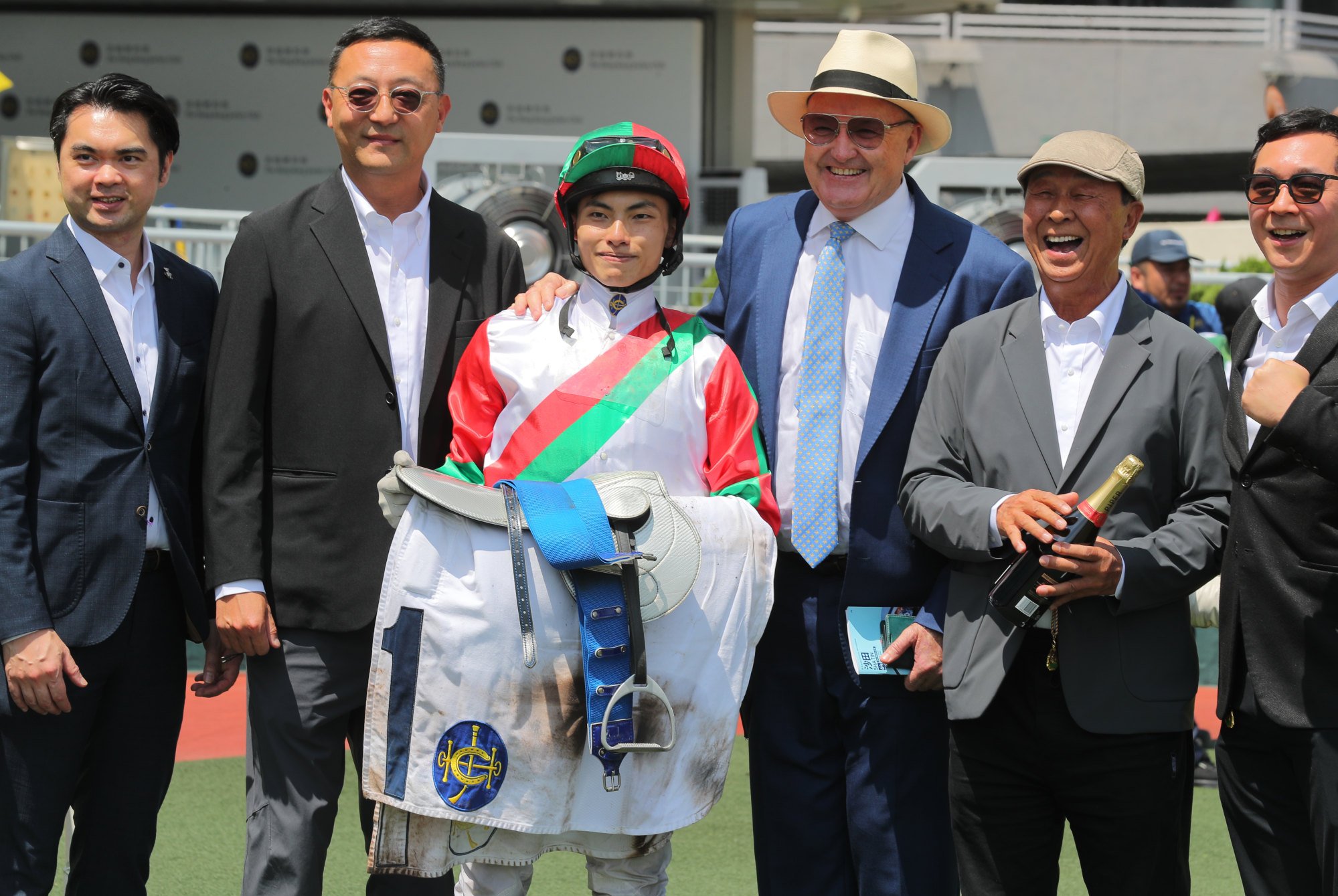 Apprentice Ellis Wong, trainer David Hayes (third from right) and connections of Solid Shalaa celebrate.