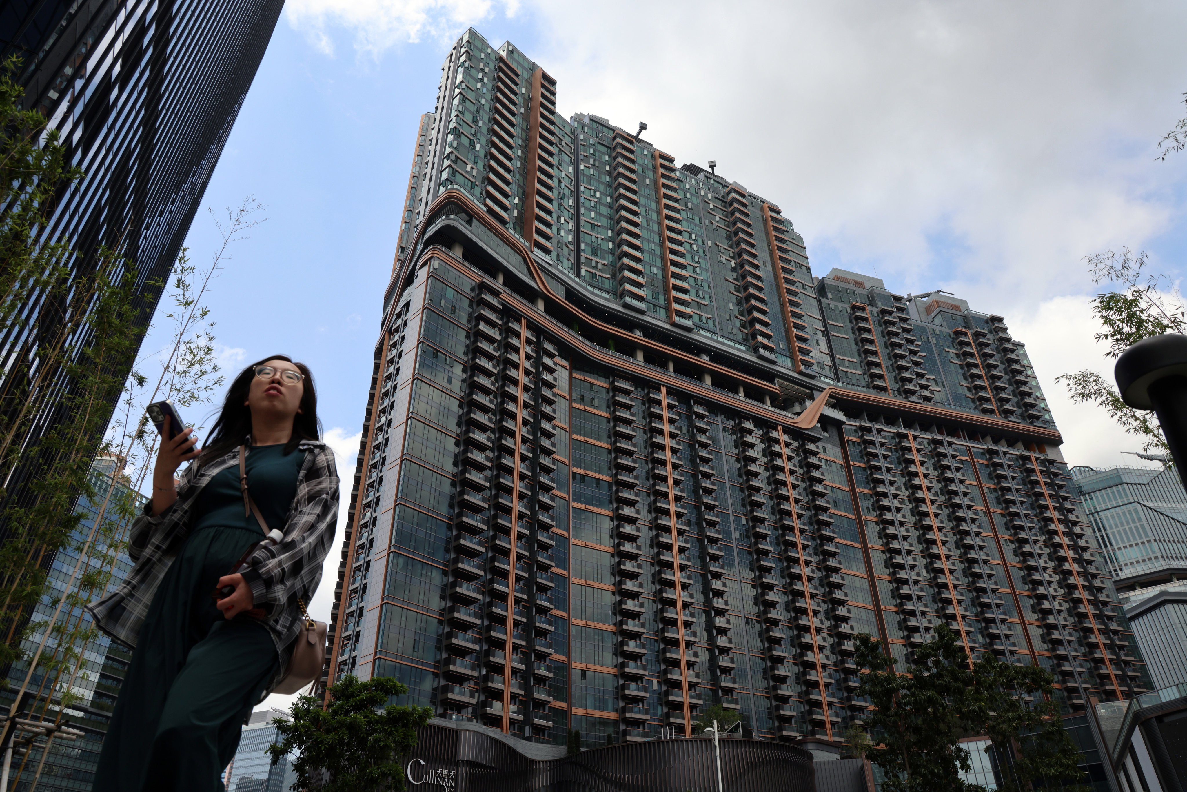 A pedestrian walks past private housing in Kai Tak. A Hong Kong think tank says private housing demand will be hurt by the ongoing trade war. Photo: Jelly Tse