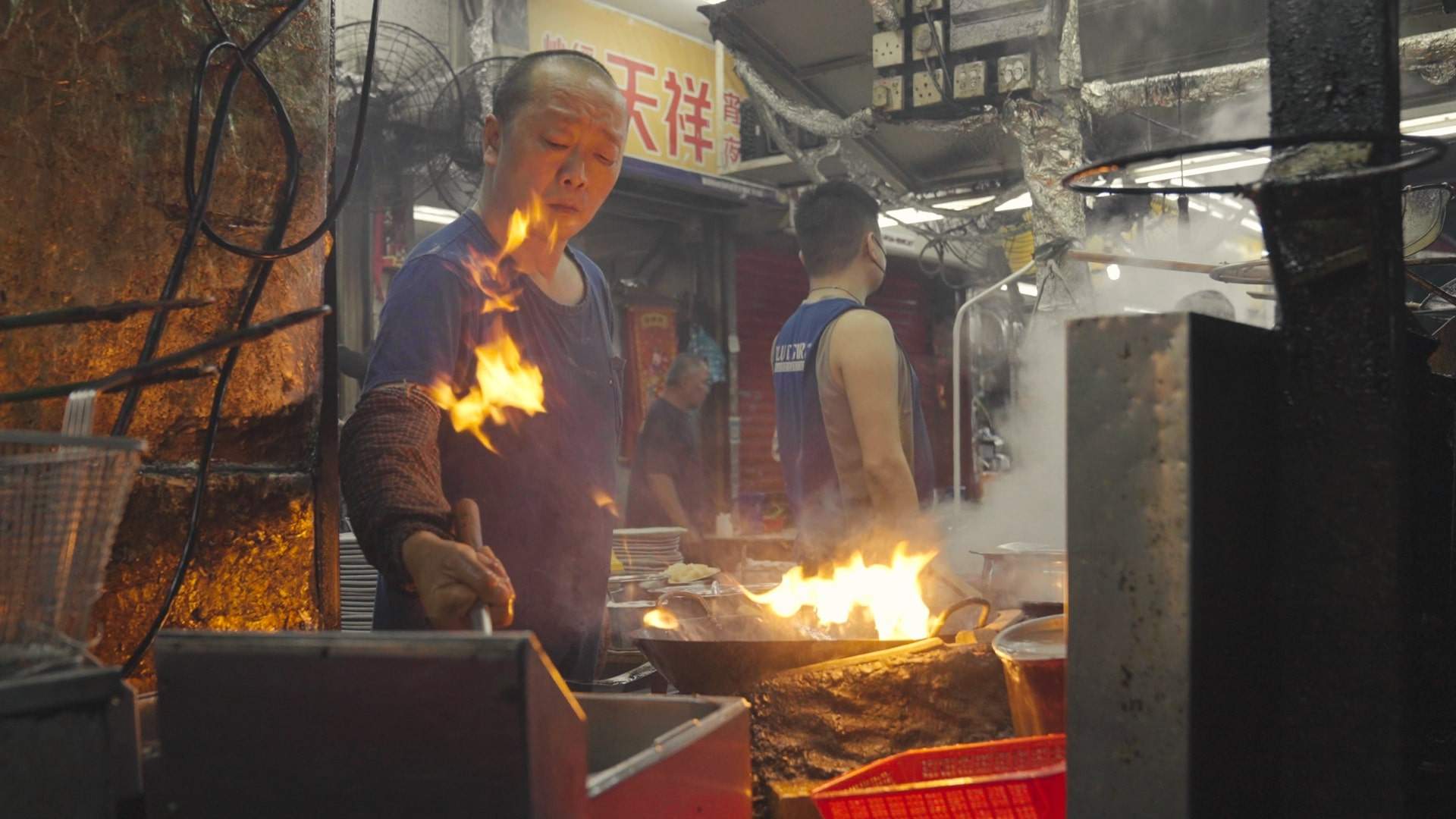 Cooks working in a dai pai dong in Hong Kong. From such street food stalls to fine-dining Cantonese restaurants, customers savour the effect of wok hei, the “breath of the wok”, in their food. Photo: Llewellyn Cheung