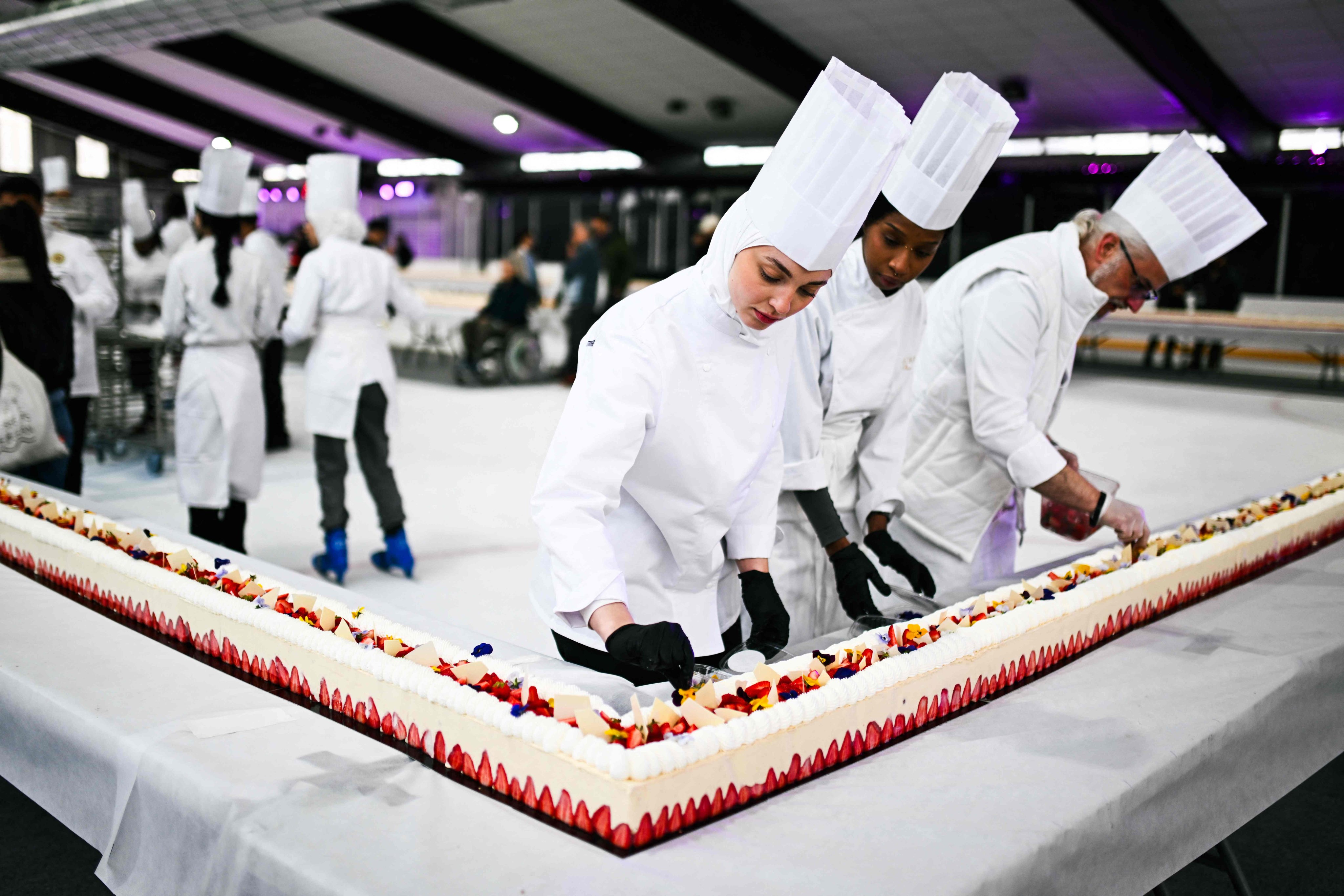 Pastry chefs work on the world’s largest strawberry cake in Argenteuil, Paris, France. Photo: AFP