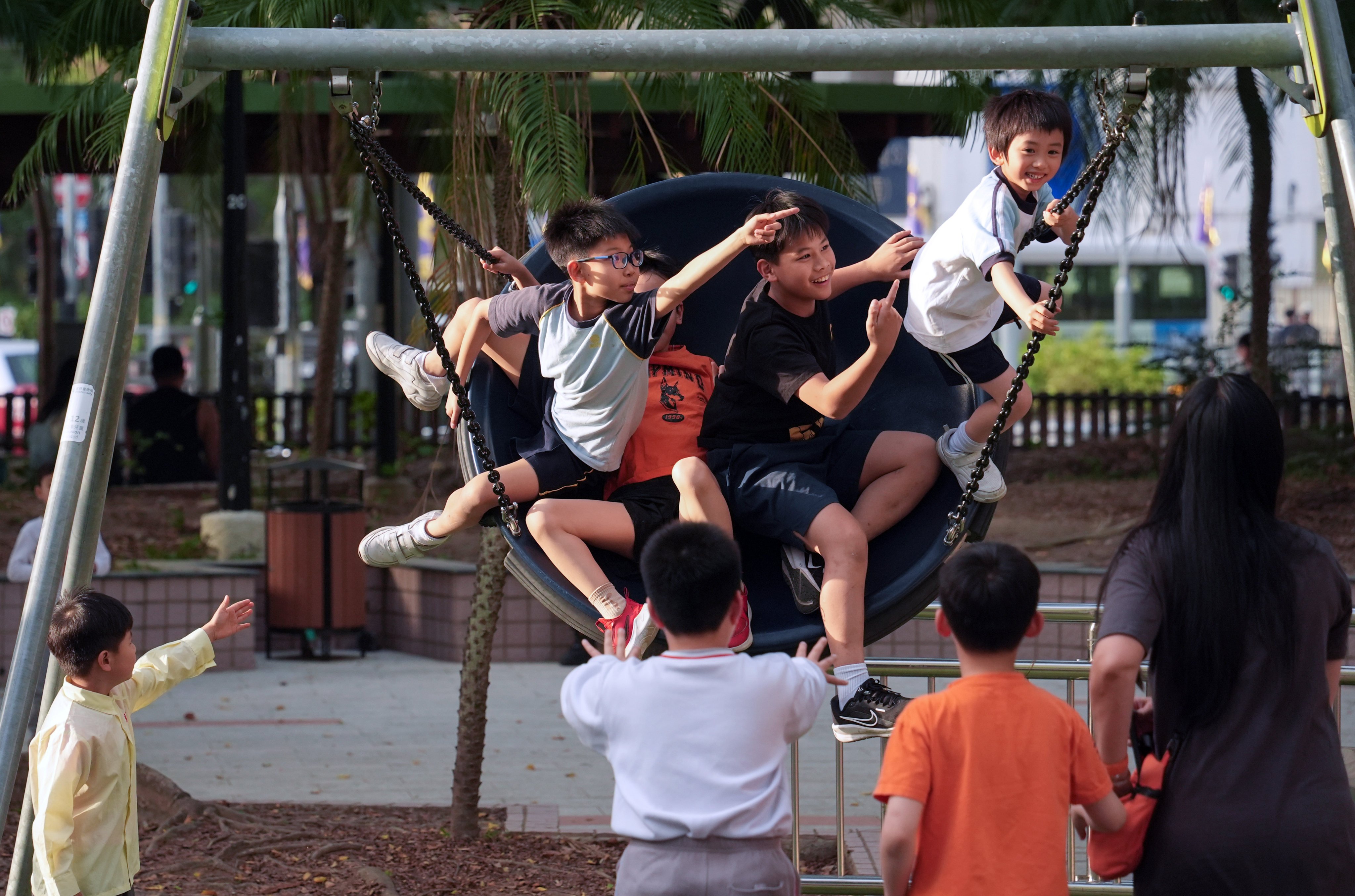 Kids play on the swing at a park in Yuen Long. Photo: Eugene Lee