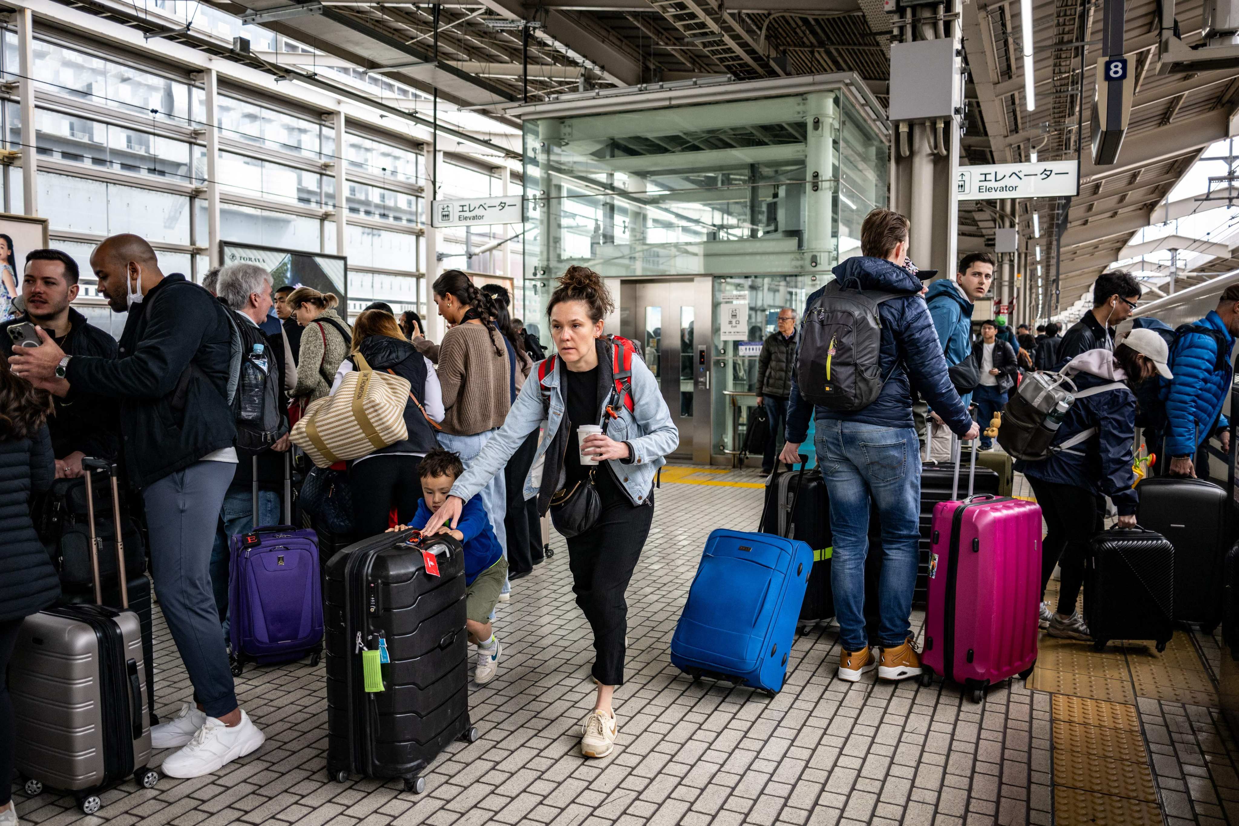 Foreign tourists gather on a platform at Kyoto station on April 16. Photo: AFP