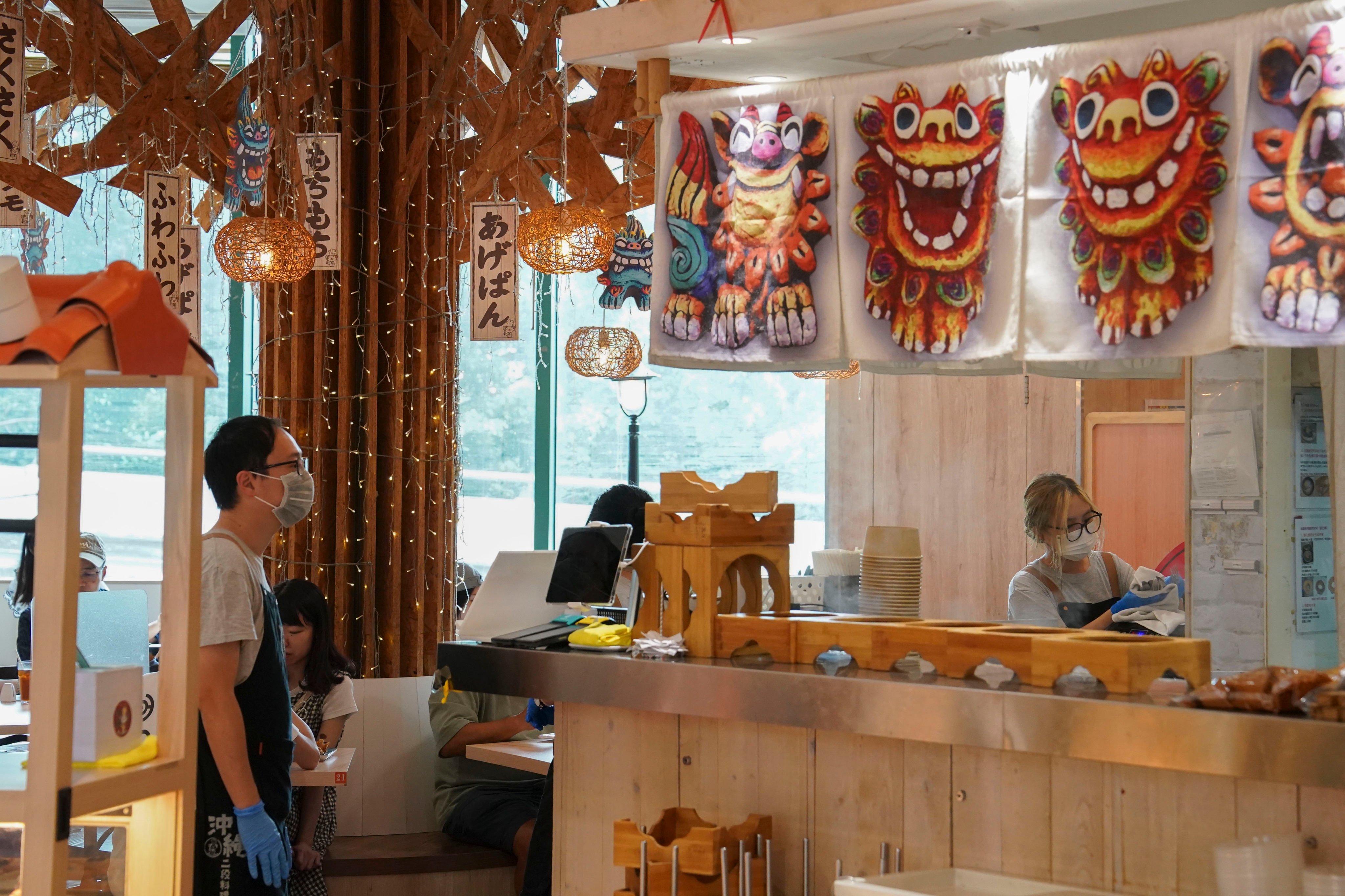 Waiters work in a restaurant at Diamond Hill. The waiting industry in particular appears to have been troubled by layoffs, and the subsequent hiring of staff from outside Hong Kong.  Photo: Elson Li