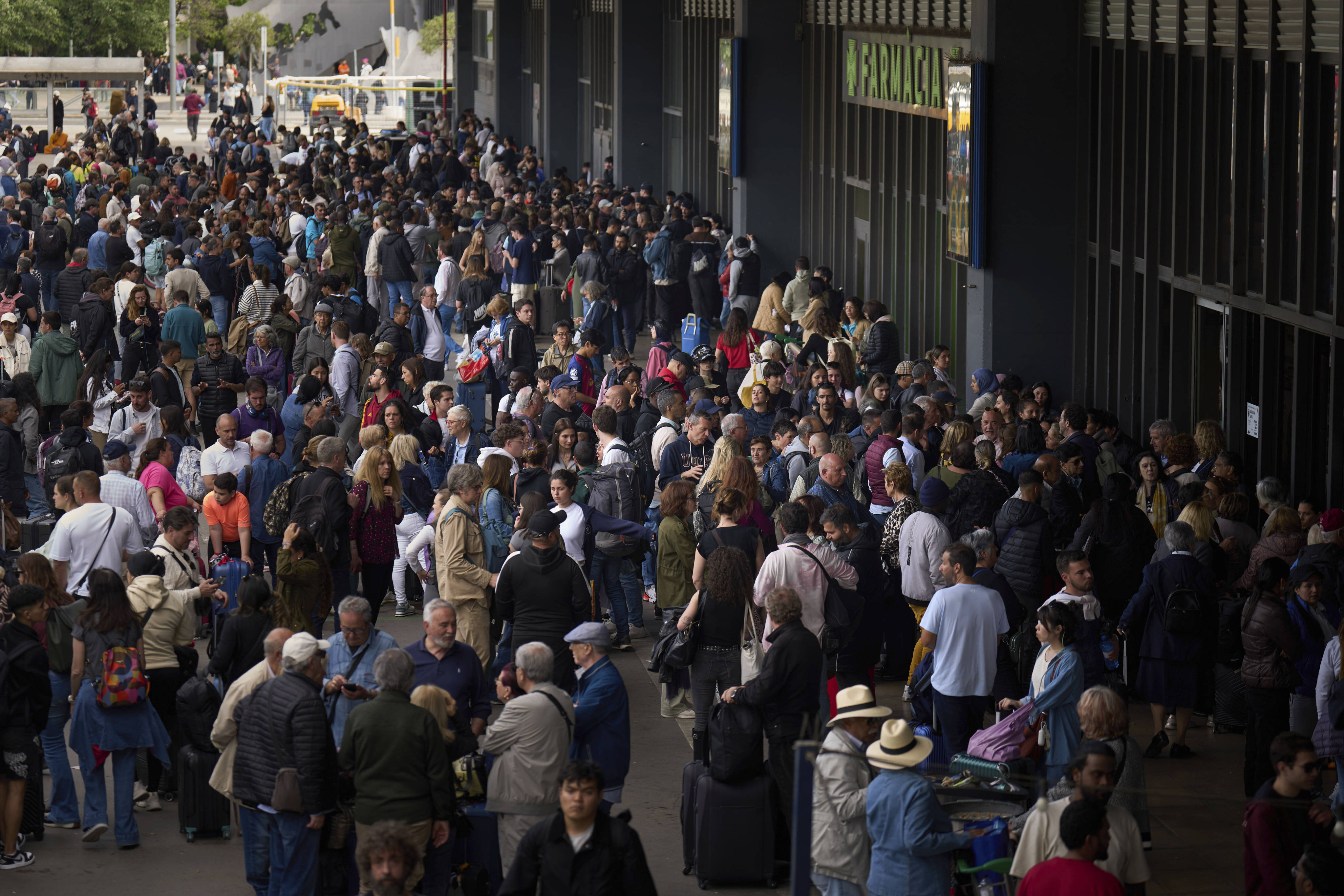 People wait outside a closed train station, during a  major power outage in Barcelona, Spain. Photo: AP