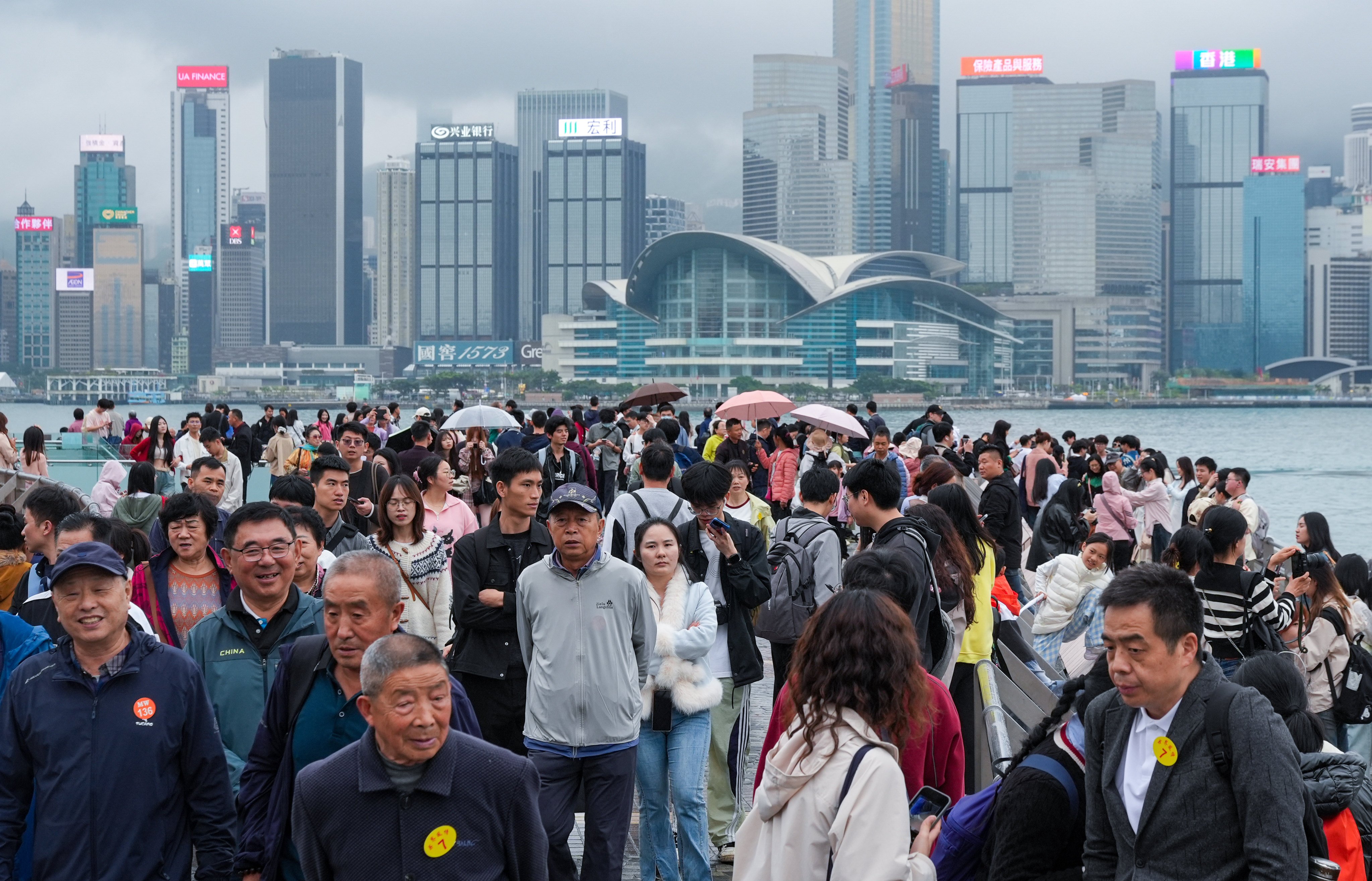 Tourists visit the Tsim Sha Tsui waterfront on a foggy and drizzly day earlier this month. Photo: Eugene Lee