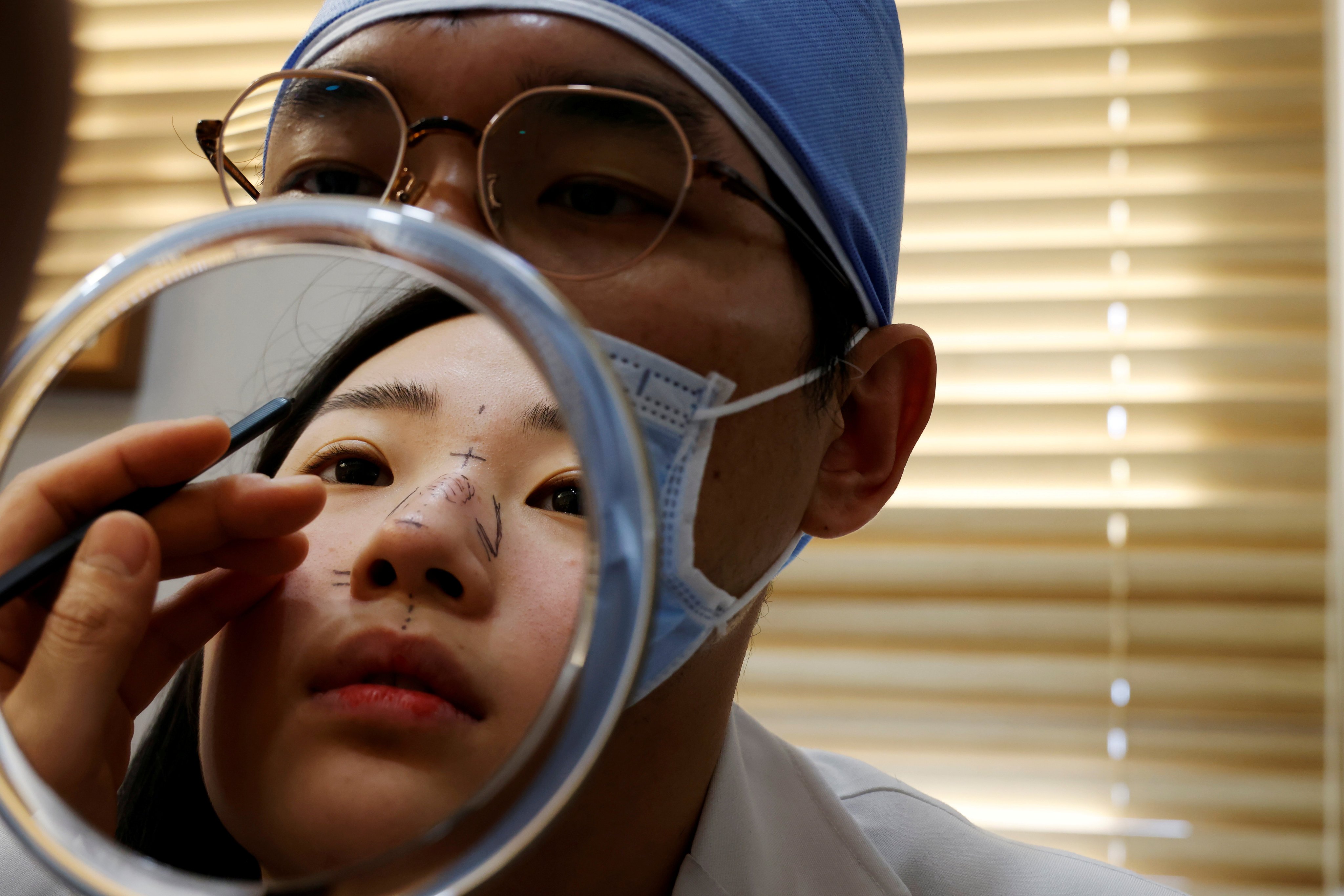 A rhinoplasty patient has a consultation with a surgeon in Seoul, South Korea. Photo: Reuters