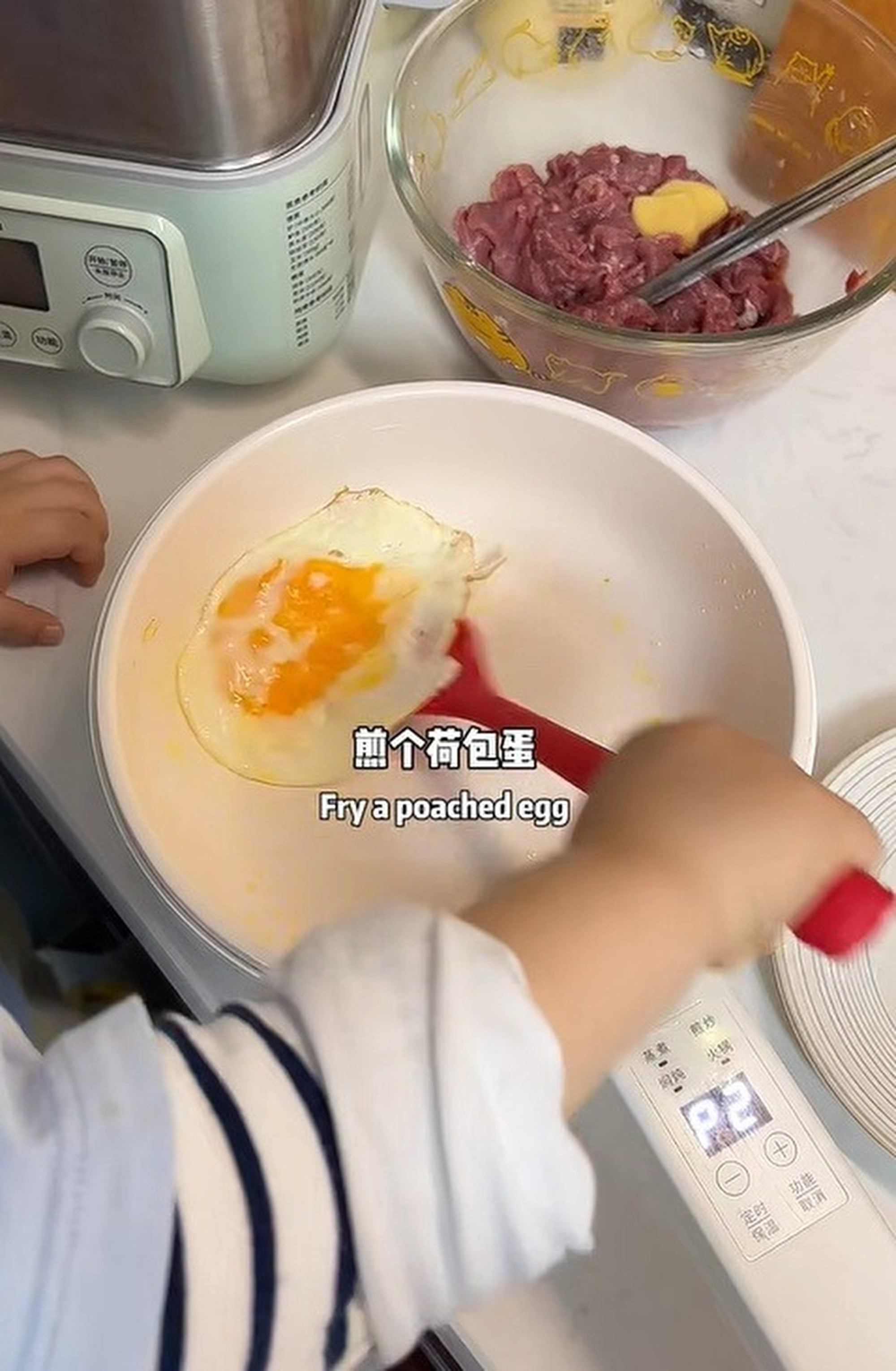 Cooking up a storm: The youngster fries an egg, just one of the many tasks he can handle, much to the delight of his mother. Photo: Weibo