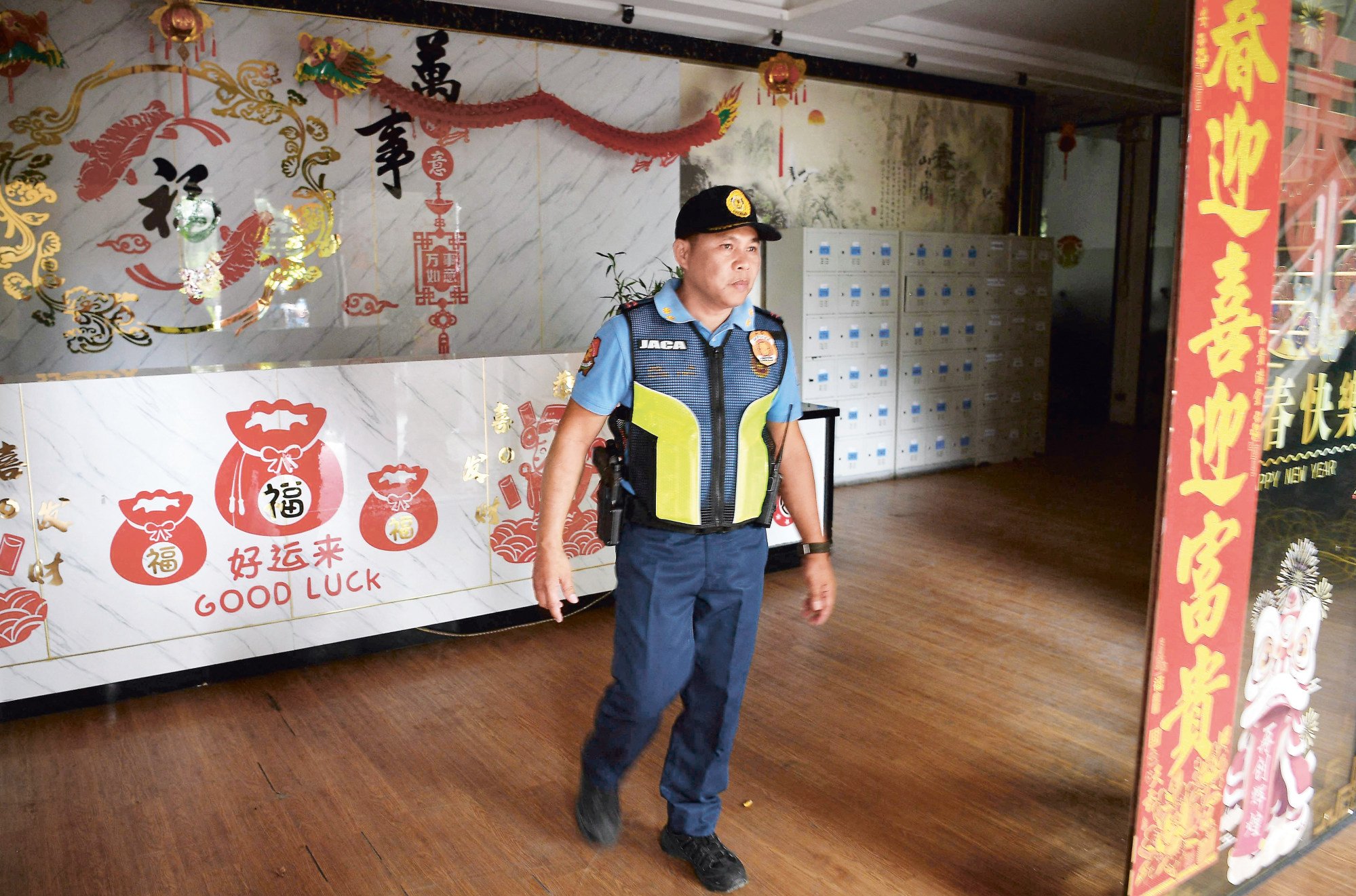 A police officer inspects a building at a closed Philippine online gaming operator hub inside the former Island Cove resort in Kawit, Cavite province. Photo: AFP