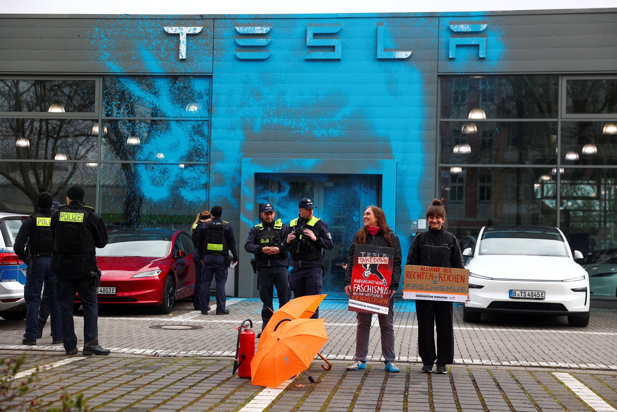 Supporters of New Generation (Neue Generation) demonstrate after they spray-painted the facade of a Tesla showroom to protest against Elon Musk and the destruction of democracy and the climate by the rich, in Berlin, Germany, on March 31. Photo: Reuters Supporters of New Generation (Neue Generation) demonstrate after they spray-painted the facade of a Tesla showroom to protest against Elon Musk and the destruction of democracy and the climate by the rich, in Berlin, Germany, on March 31. Photo: Reuters