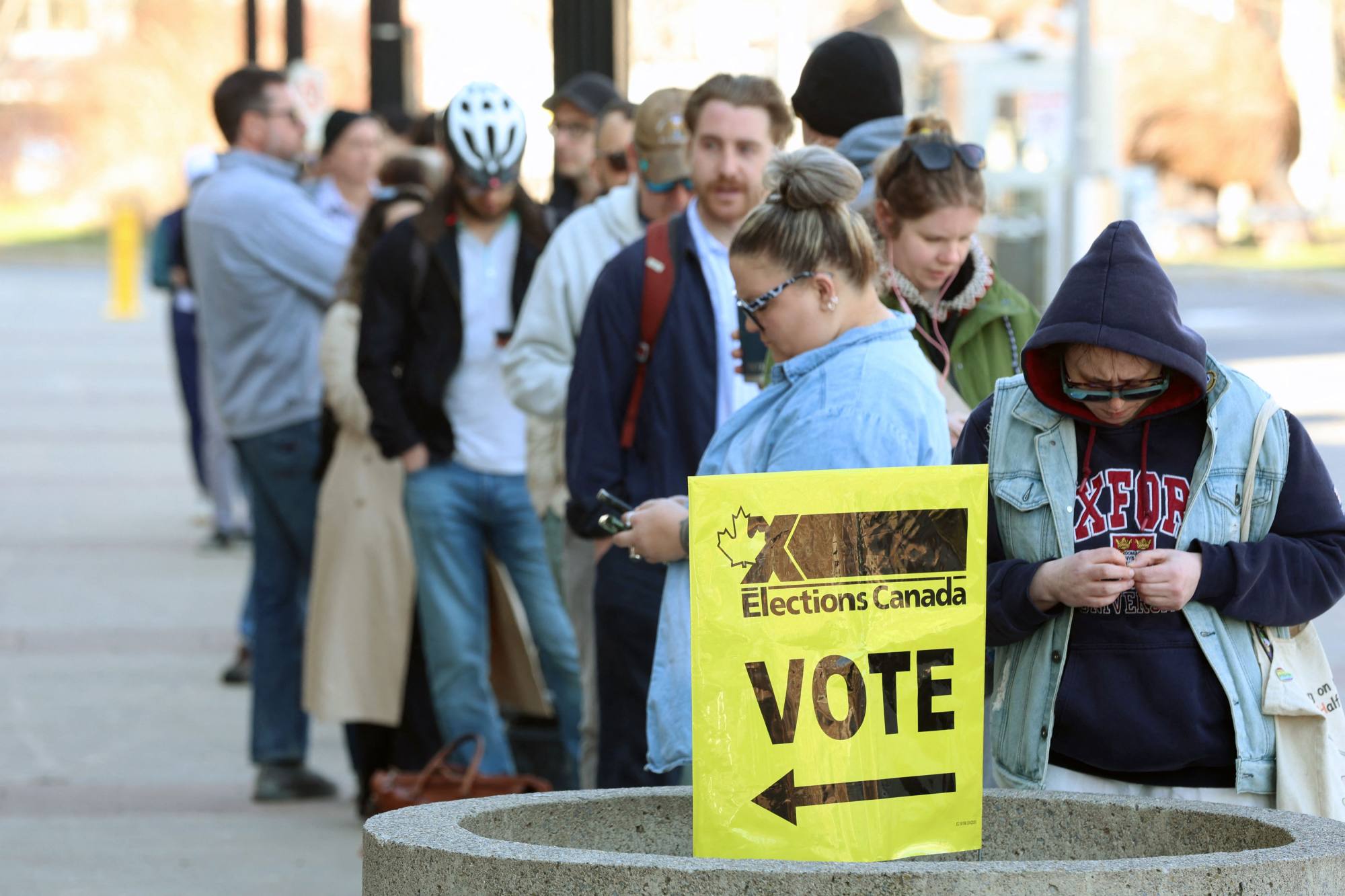 Voters line up outside a polling station to cast their ballots in Canada’s election in Ottawa on Monday. Photo: AFP Voters line up outside a polling station to cast their ballots in Canada’s election in Ottawa on Monday. Photo: AFP