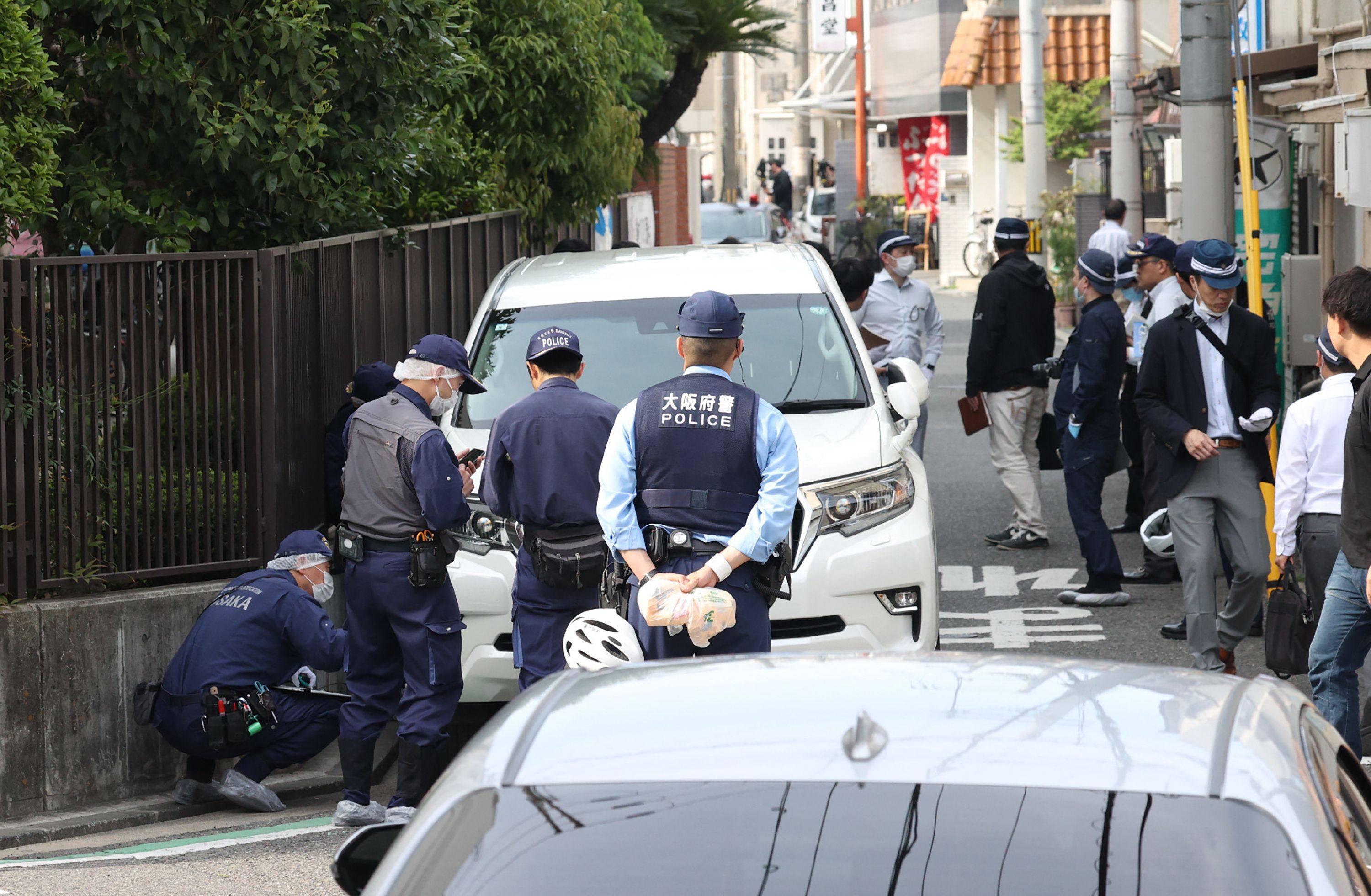 Police officers investigate the scene in Osaka’s Nishinari district on Thursday after a man was arrested for ploughing his car into seven schoolchildren in a suspected deliberate attack. Photo: AFP