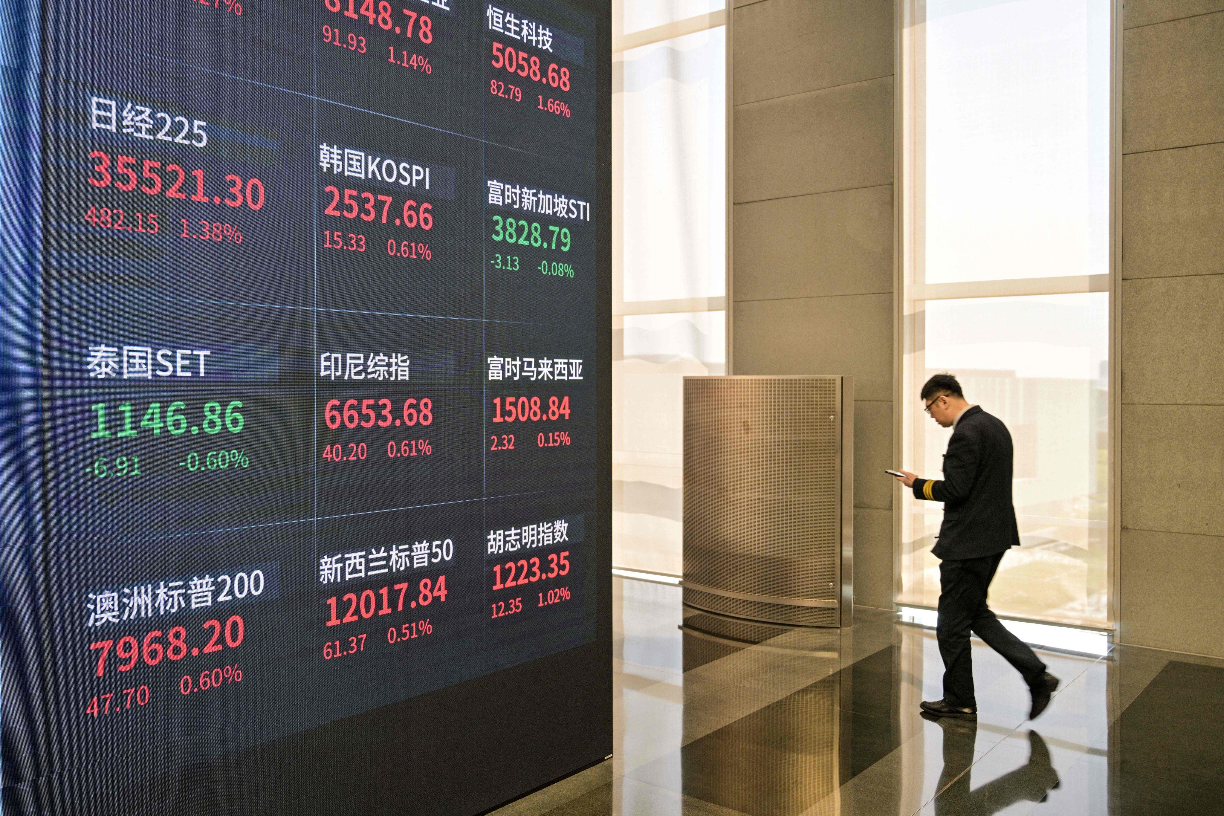 A screen shows financial market movements at the new Shanghai Stock Exchange building in Shanghai on April 25. Photo: AFP