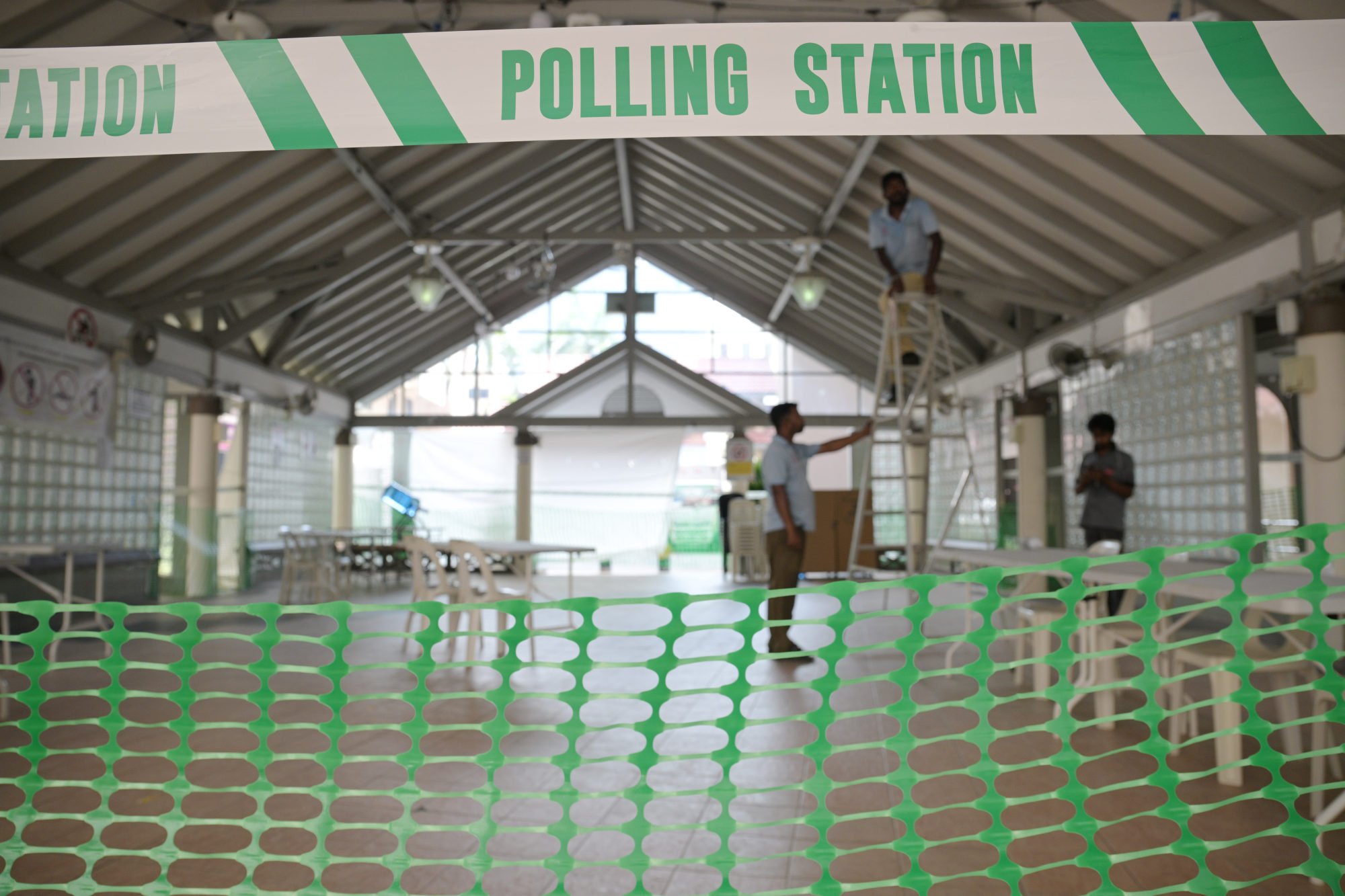 Workers set up a polling station in a pavilion of a public housing neighbourhood ahead of the general election. Photo: Xinhua Workers set up a polling station in a pavilion of a public housing neighbourhood ahead of the general election. Photo: Xinhua