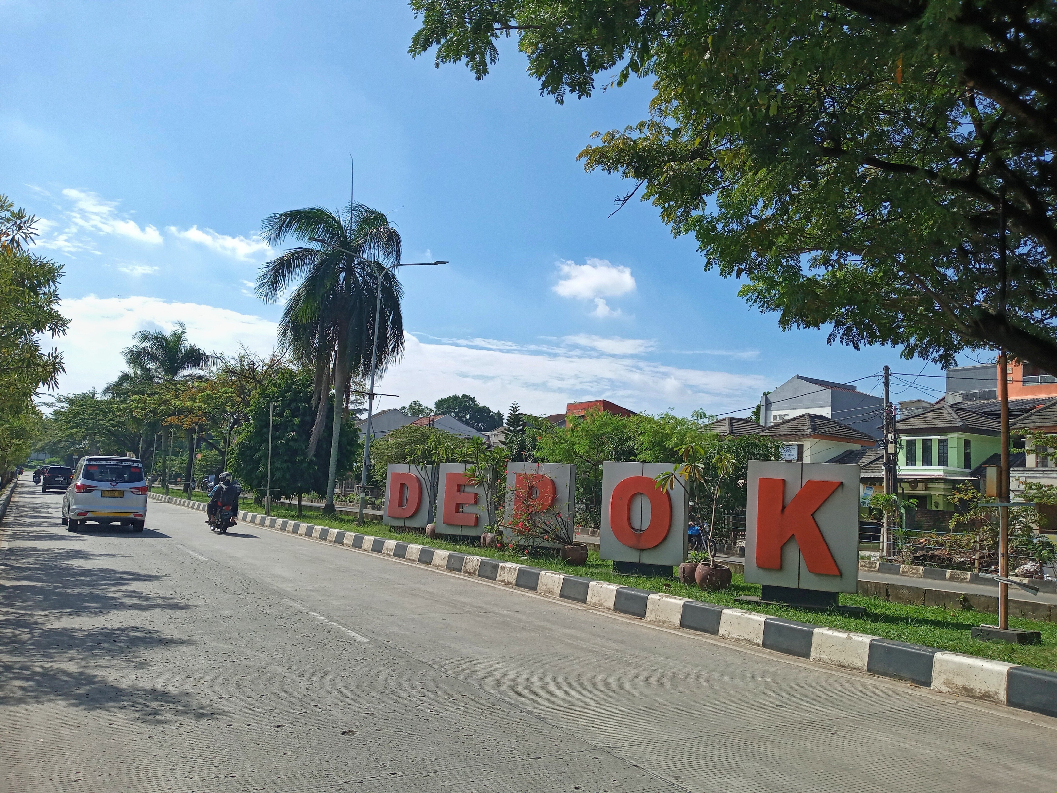 A sunny street view with large “Depok” city sign on the roadside. 
The Indonesian city has seen a recent increase in youth crimes, such as drug use and violence. Photo: Shutterstock