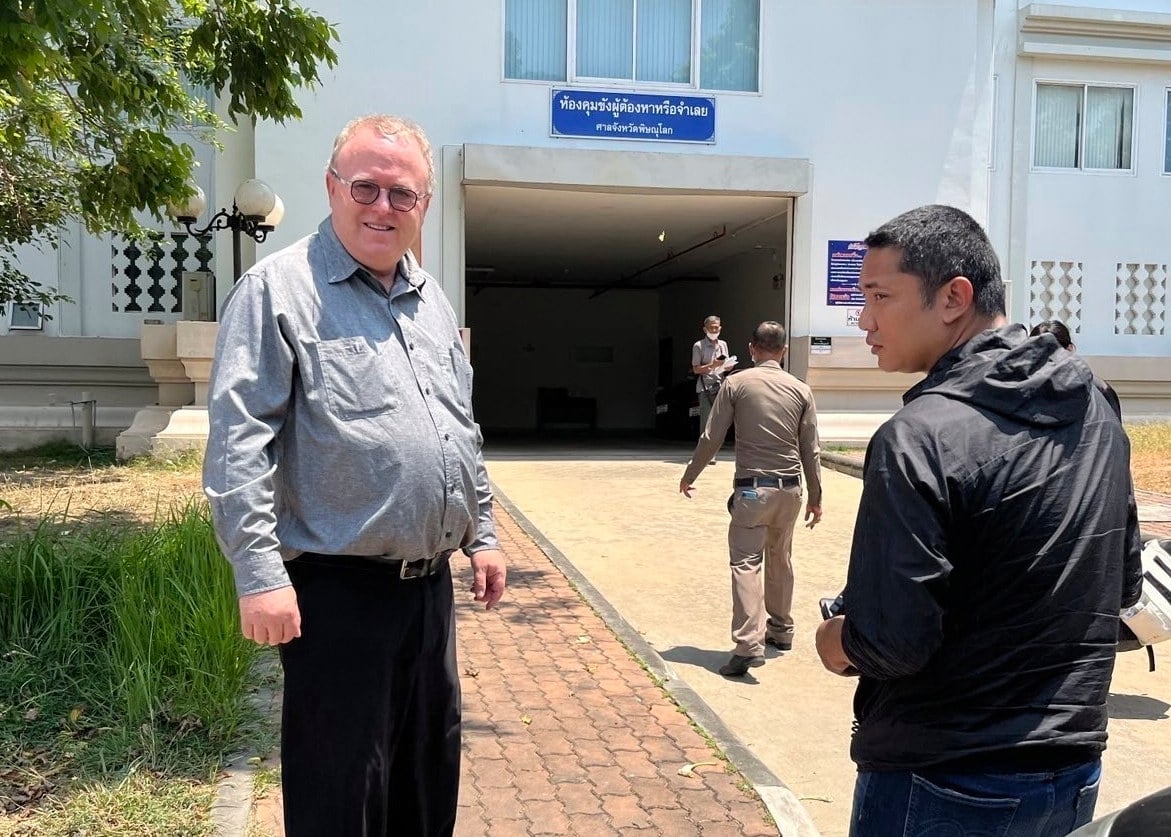 US political science lecturer Paul Chambers (left) of Thailand’s Naresuan University, stands outside the police station in Phitsanulok, Thailand, where he was arrested on April 8, 2025, on charges of insulting the monarchy. Photo: AP
