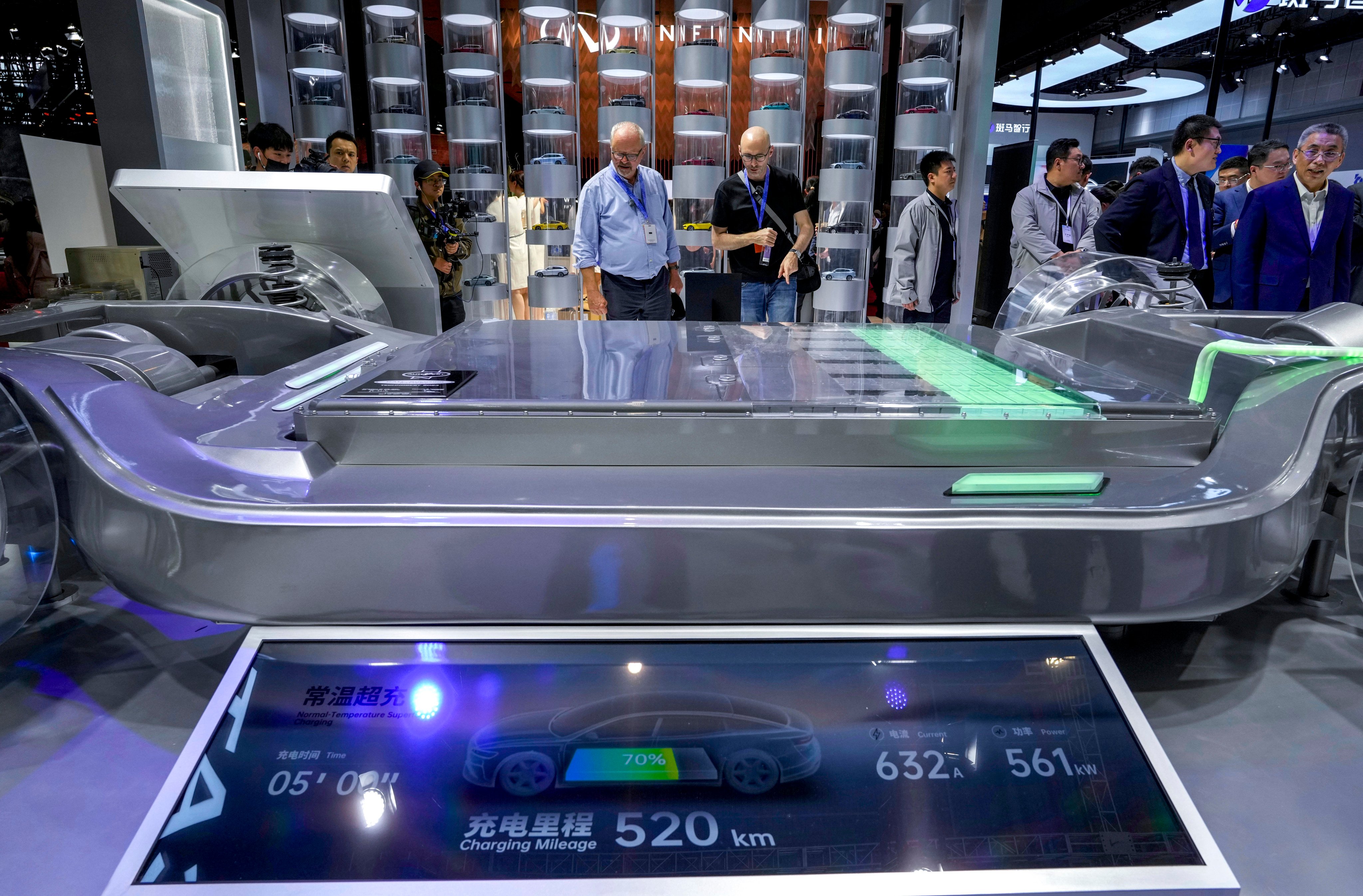 Visitors look at a fast-charging battery from CATL. Photo: AP