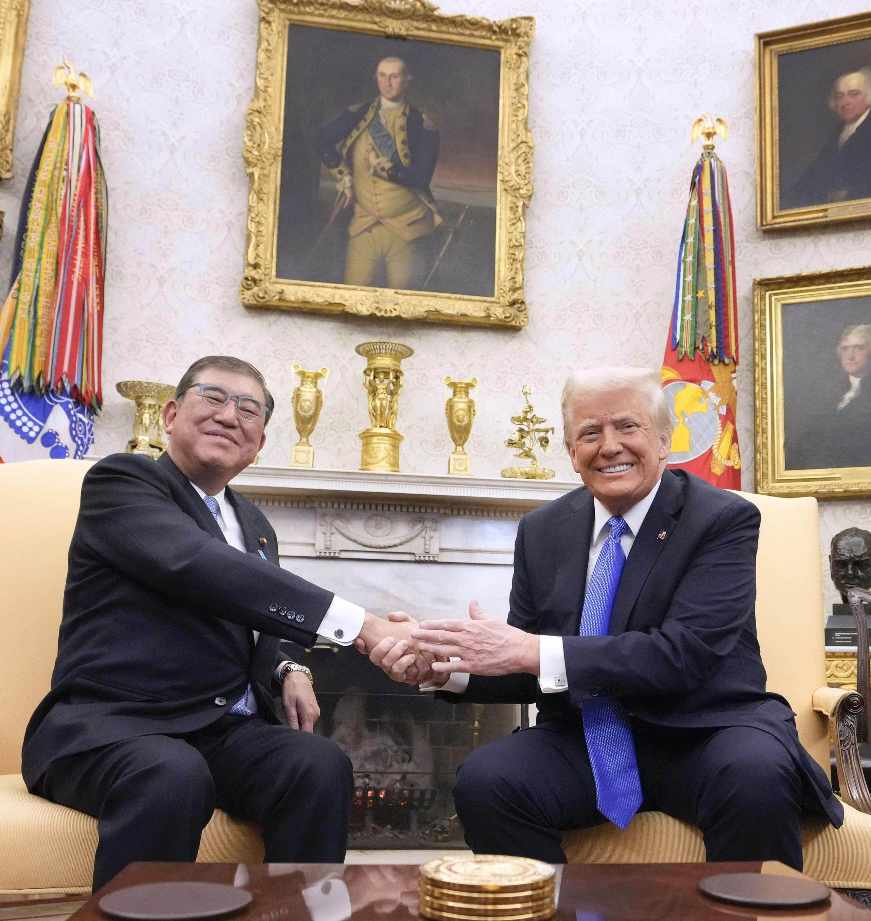 Japanese Prime Minister Shigeru Ishiba (left) shakes hands with US President Donald Trump at the White House on February 7. Photo: Kyodo
