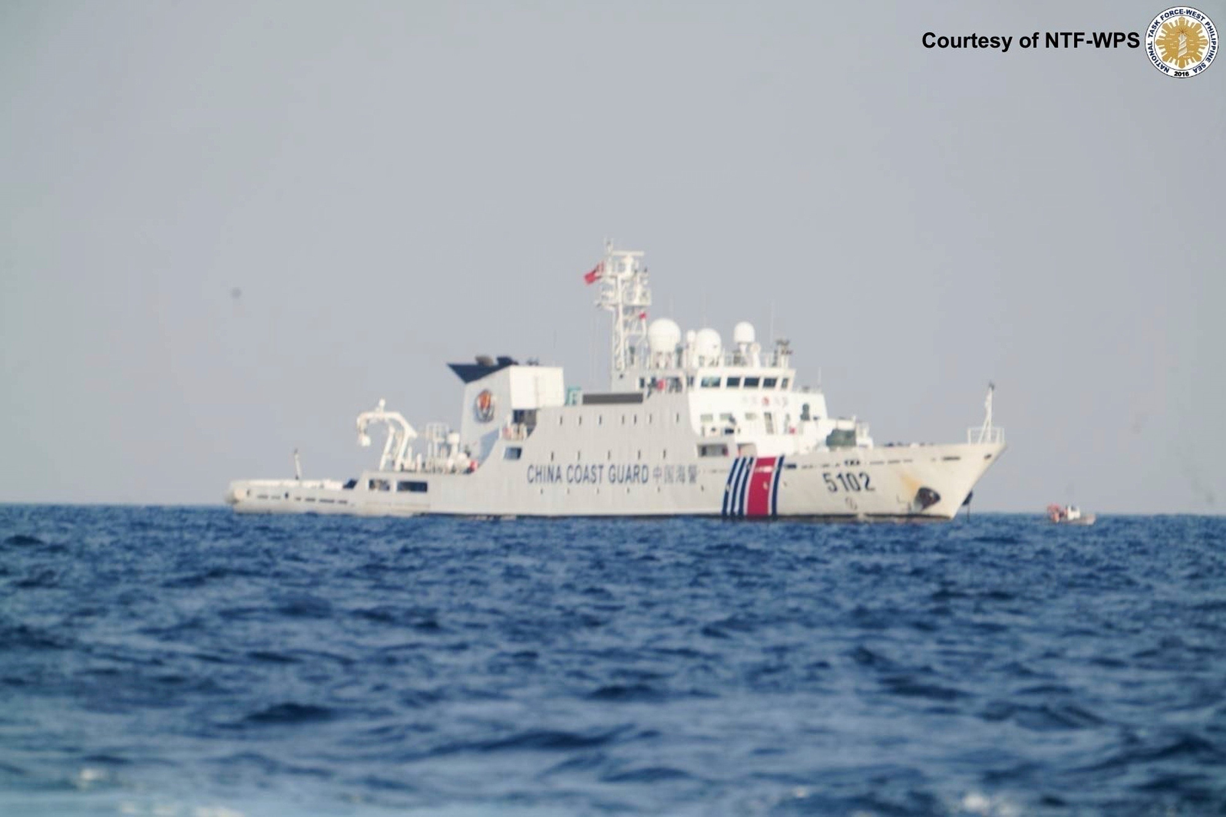 A Chinese coastguard ship patrols the area as Philippine inter-agency members visit Sandy Cay in the South China Sea on April 27. Photo: National Task Force West Philippine Sea/AP