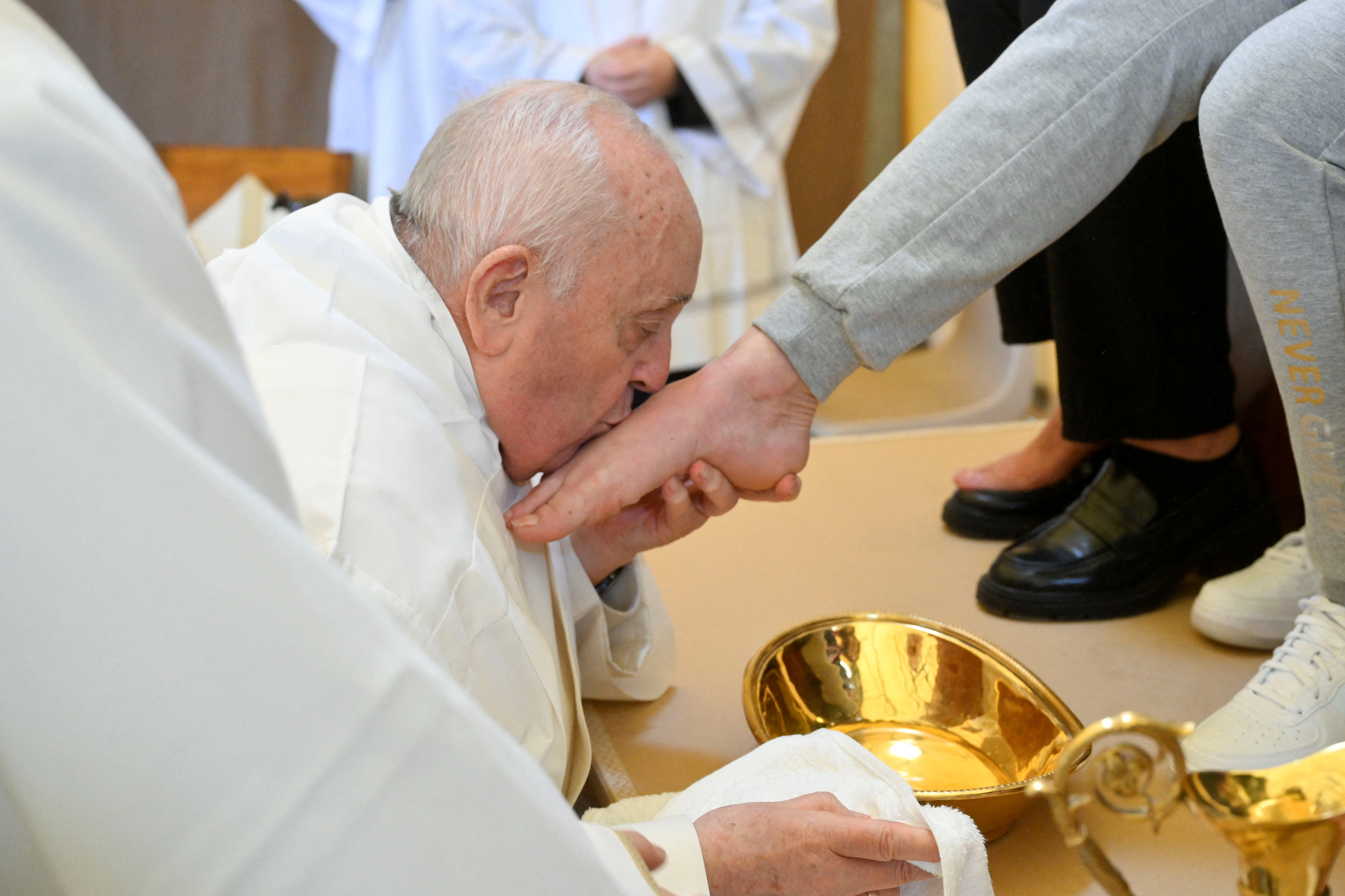 Pope Francis kisses the feet of an inmate in the female section of the Rebibbia prison during a Holy Thursday ritual in Rome, Italy on March 28, 2024. Photo: Vatican Media/Reuters