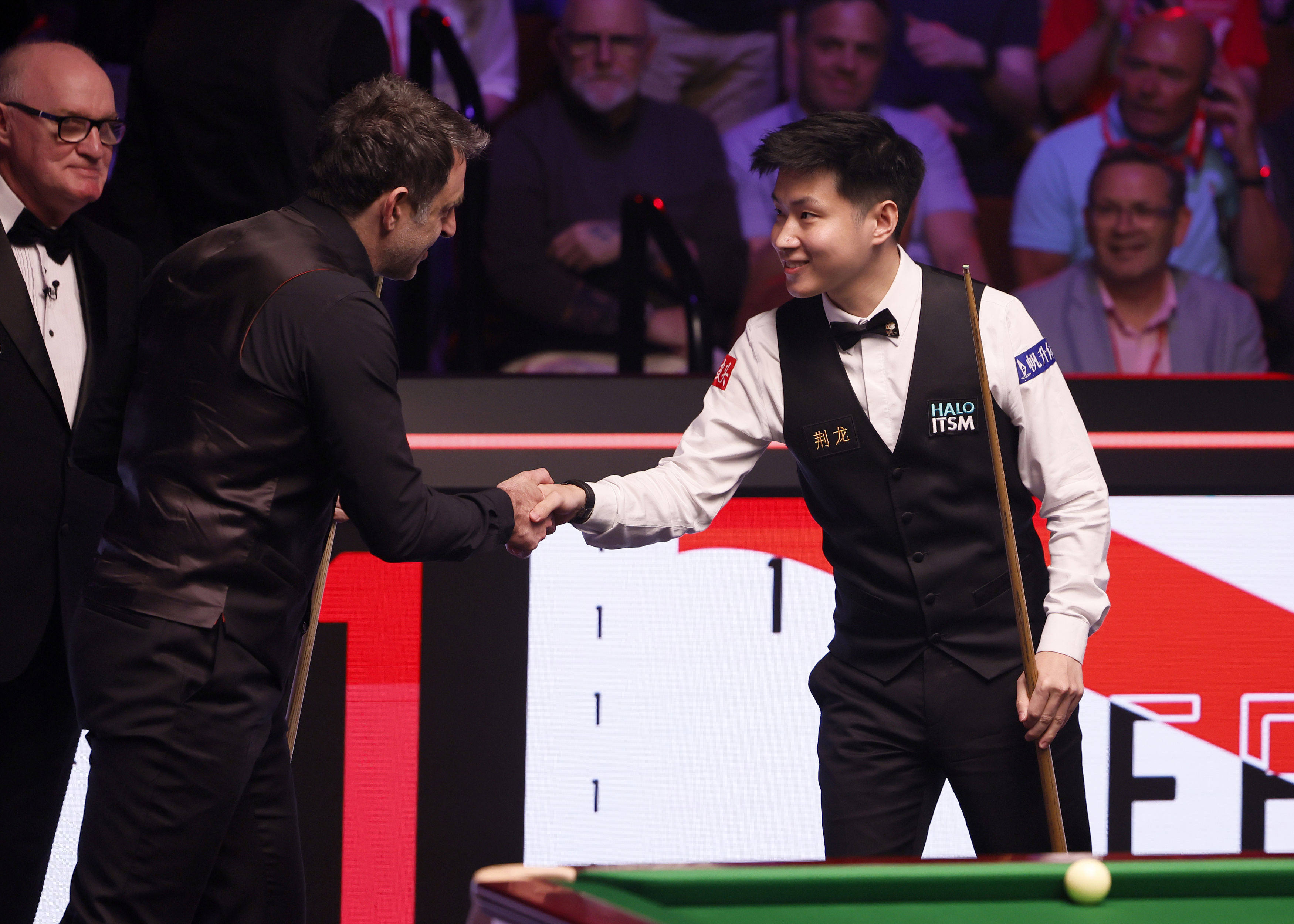 Ronnie O’Sullivan shakes hands with Zhao Xintong (right) ahead of their World Snooker Championship semi-final at the Crucible. Photo: AP