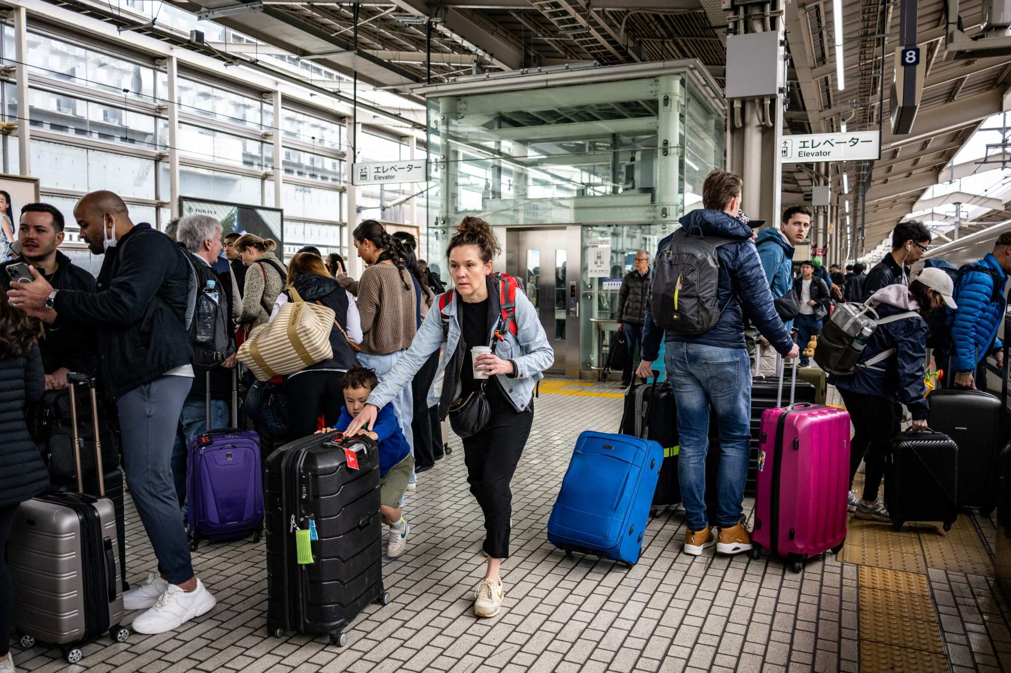 Foreign tourists gather on a platform at Kyoto station on April 16. Photo: AFP Foreign tourists gather on a platform at Kyoto station on April 16. Photo: AFP
