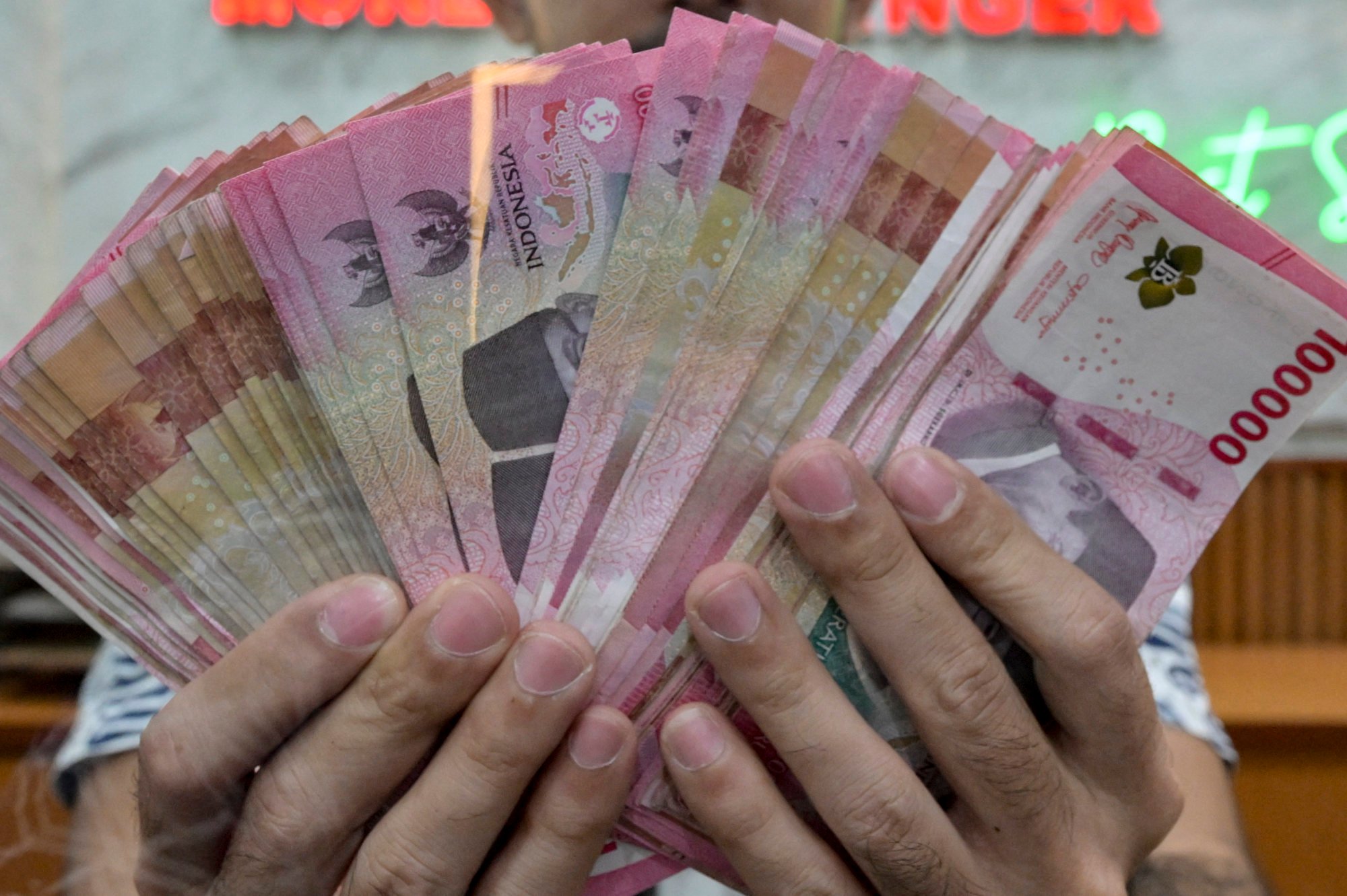 Indonesian rupiah banknotes at a money changer in Jakarta. Photo: AFP Indonesian rupiah banknotes at a money changer in Jakarta. Photo: AFP