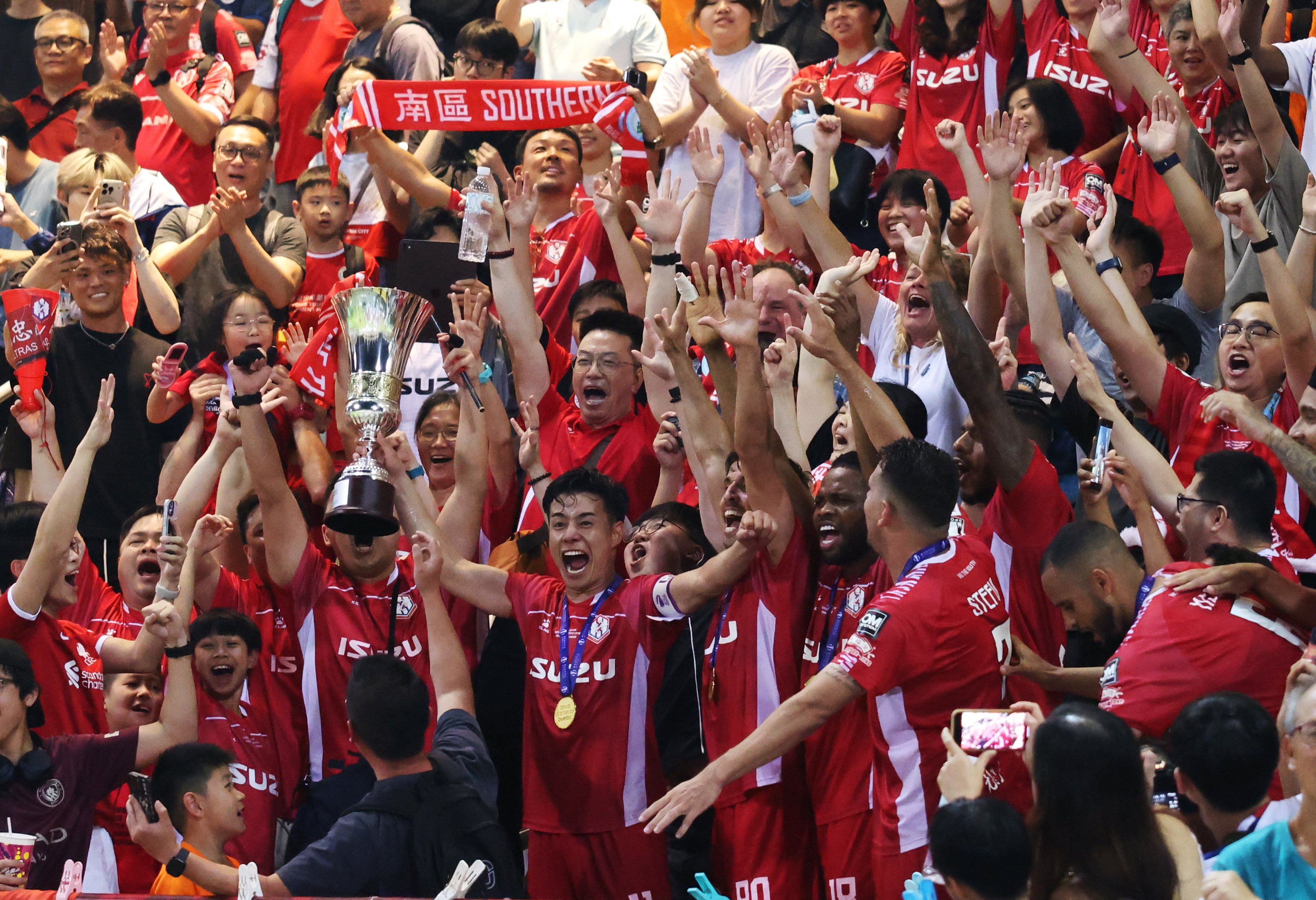 Shu Sasaki clutches the Sapling Cup as he orchestrates jubilant post-match celebrations. Photo: Nora Tam