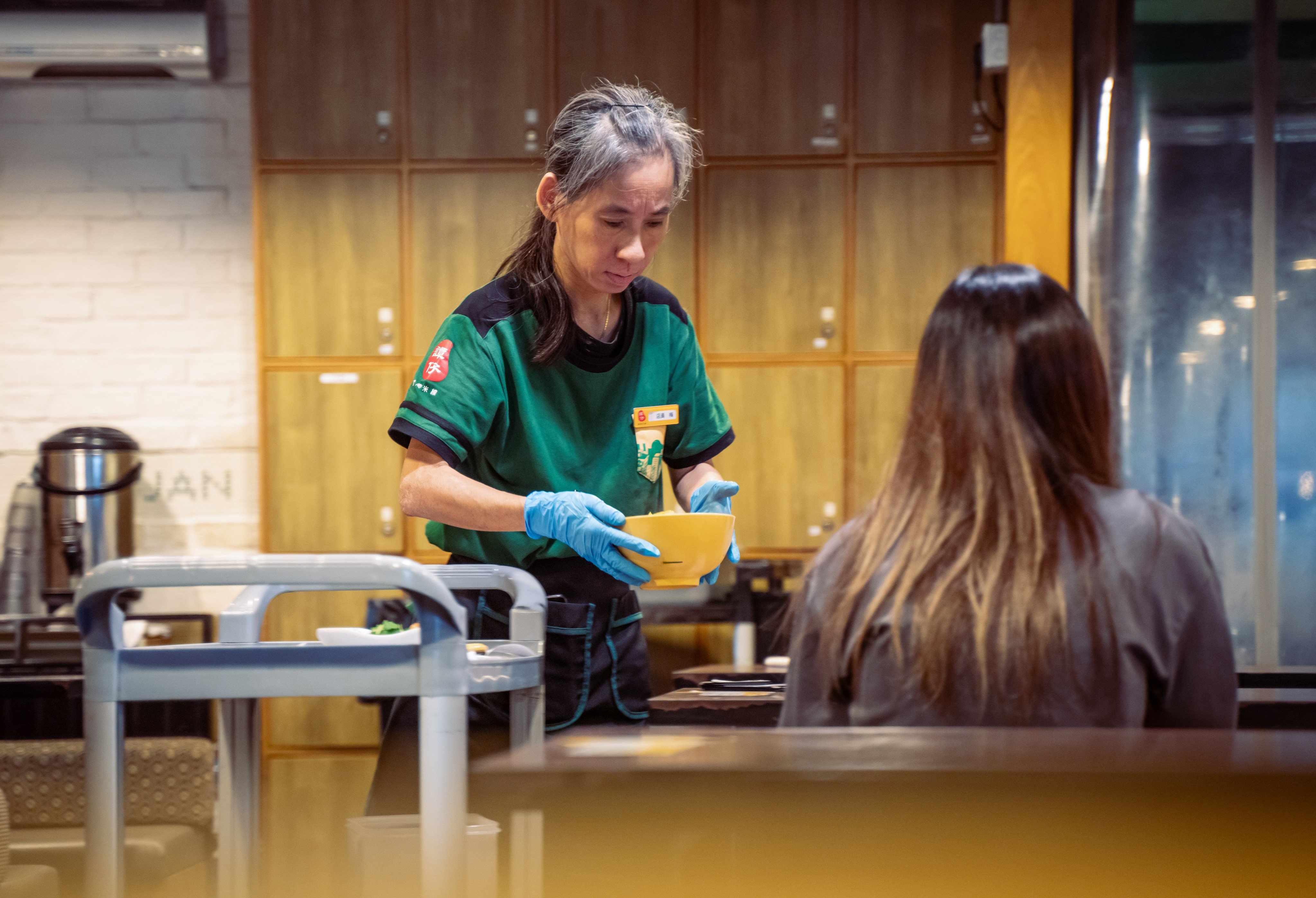 A waitress at a Tam Jai restaurant in Hong Kong. Photo: Alexander Mak