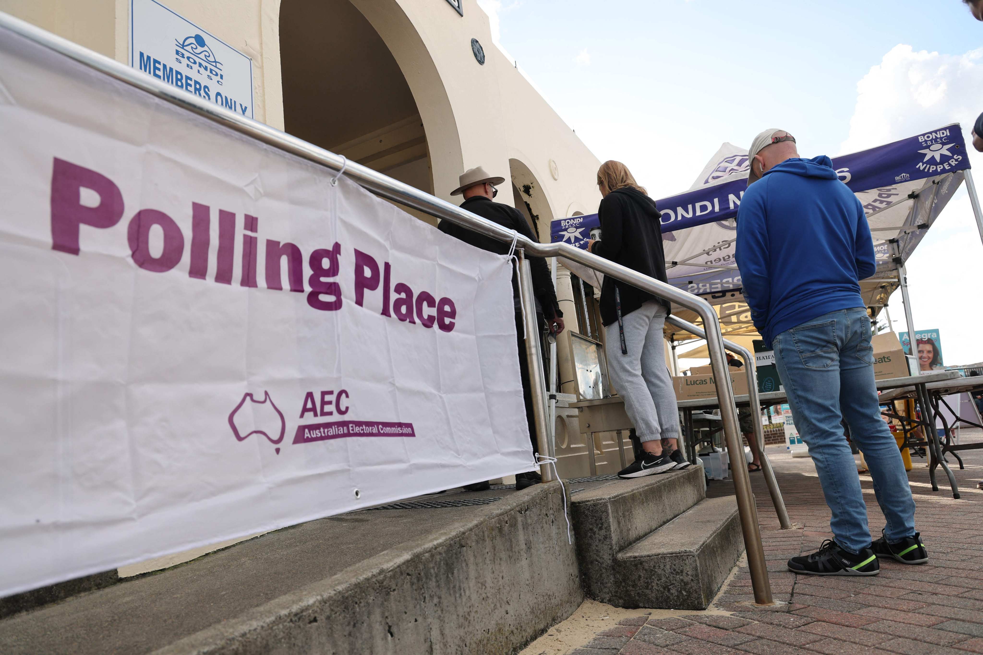 People queue at a polling centre in the Bondi Surf Bathers Life Saving Club in Sydney on Saturday. Photo: AFP