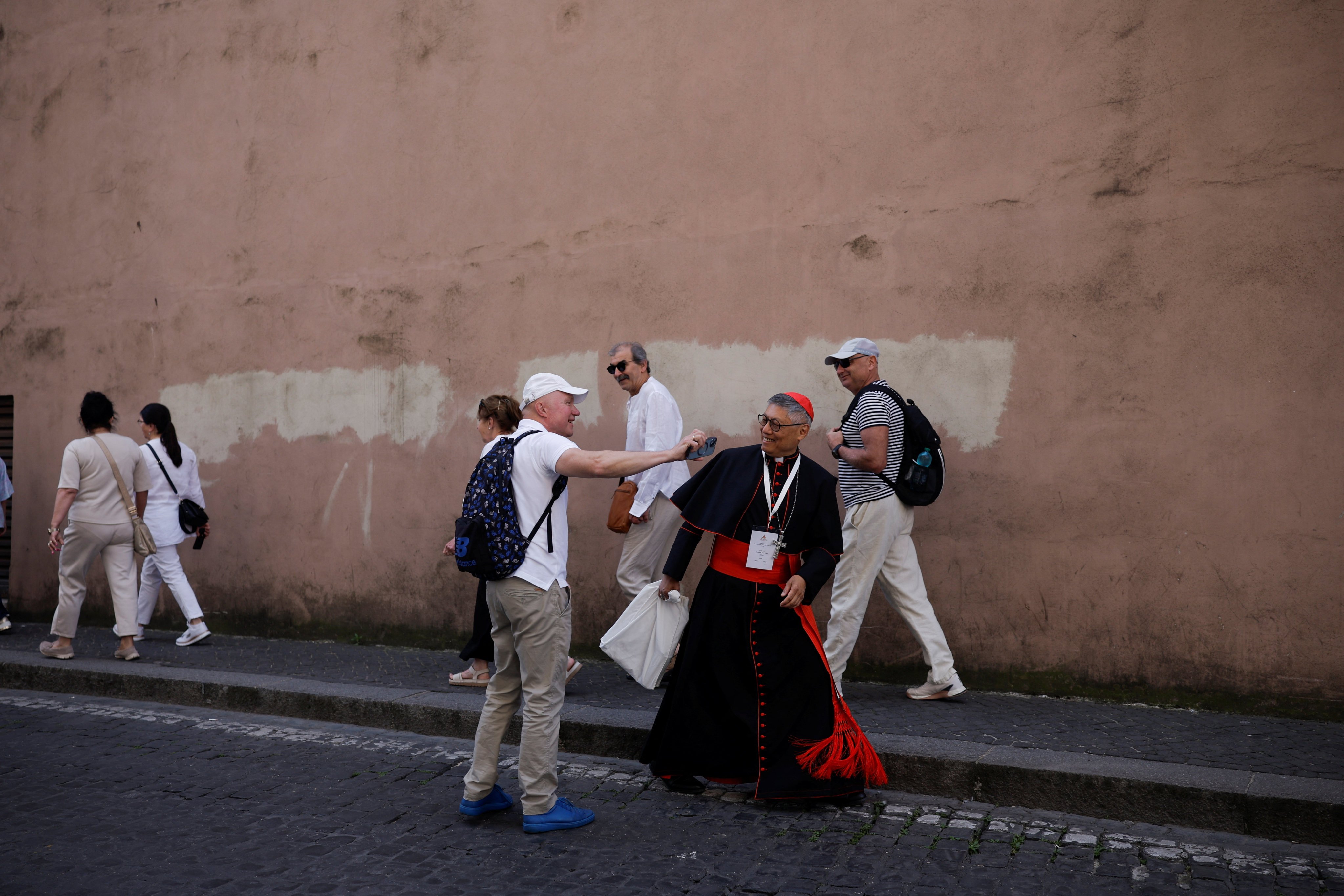 Cardinal Stephen Chow of Hong Kong greets people in Rome on May 3, 2025, as he heads to a general congregation meeting ahead of the conclave to elect the next pope. Photo: Reuters