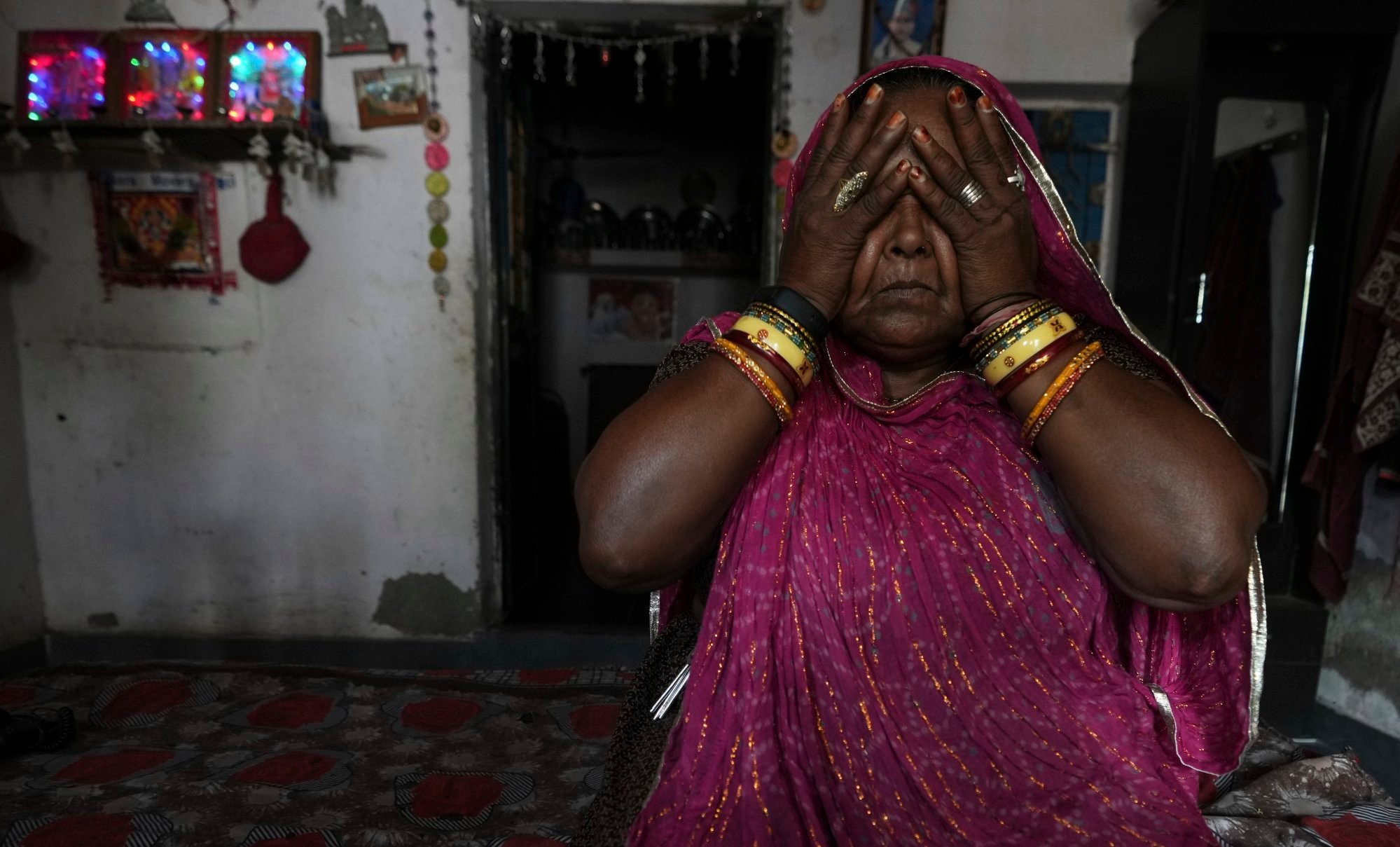 Shantaben Vanzara, wearing a wristwatch-style health monitor to study how heat affects vulnerable communities, wipes her face inside her house in Ahmedabad on April 2. Photo: AP Shantaben Vanzara, wearing a wristwatch-style health monitor to study how heat affects vulnerable communities, wipes her face inside her house in Ahmedabad on April 2. Photo: AP