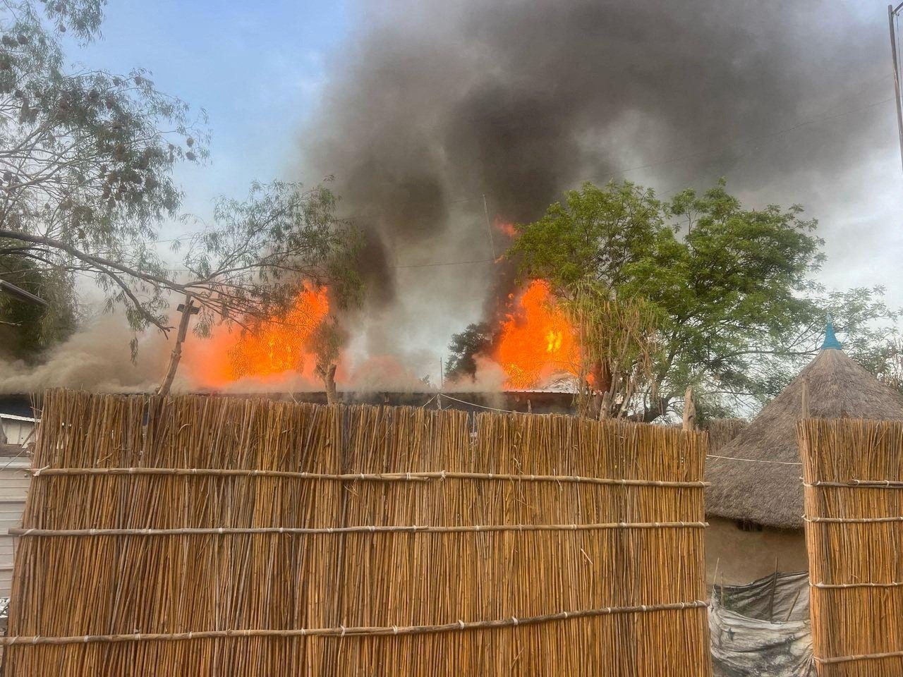 Fire burns following an aerial bombardment that resulted in deaths at the medical charity Medecins Sans Frontieres facility in South Sudan on Saturday. Photo: Handout via Reuters