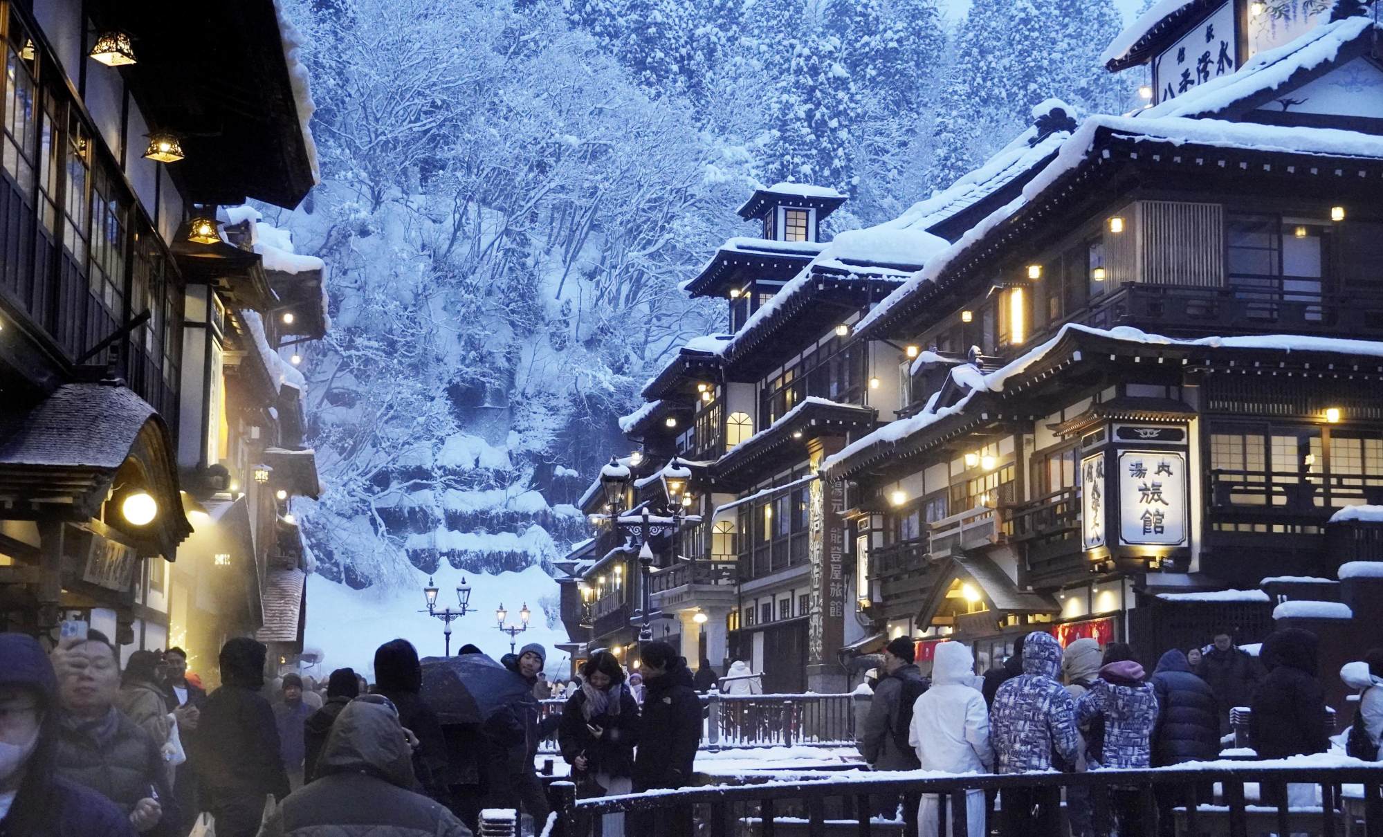 A street lined with snow-covered traditional Japanese inns at the Ginzan Onsen hot spring resort is crowded with tourists in January. Photo: Kyodo A street lined with snow-covered traditional Japanese inns at the Ginzan Onsen hot spring resort is crowded with tourists in January. Photo: Kyodo