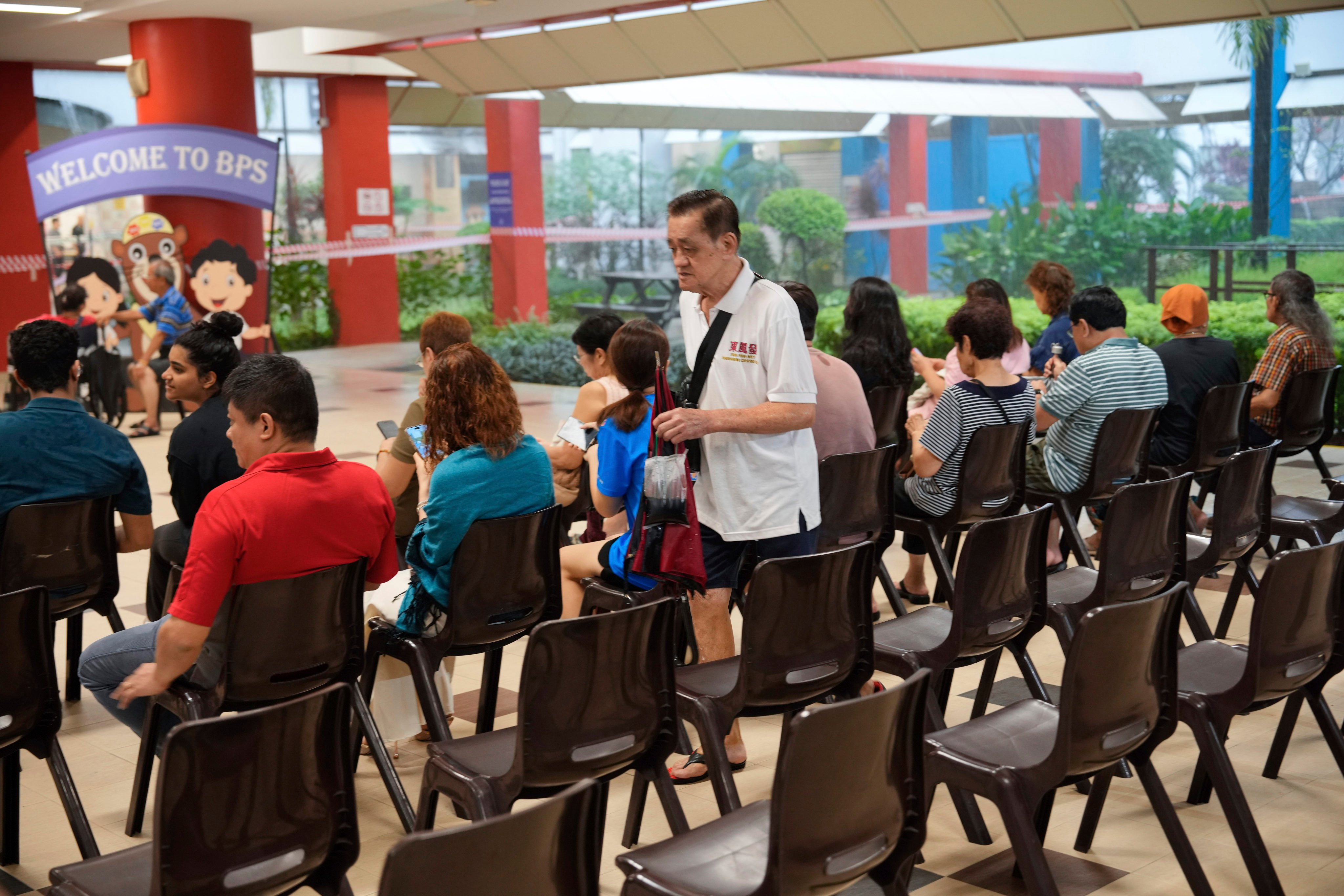 Voters wait at a polling station in Singapore on Saturday. Photo: AP